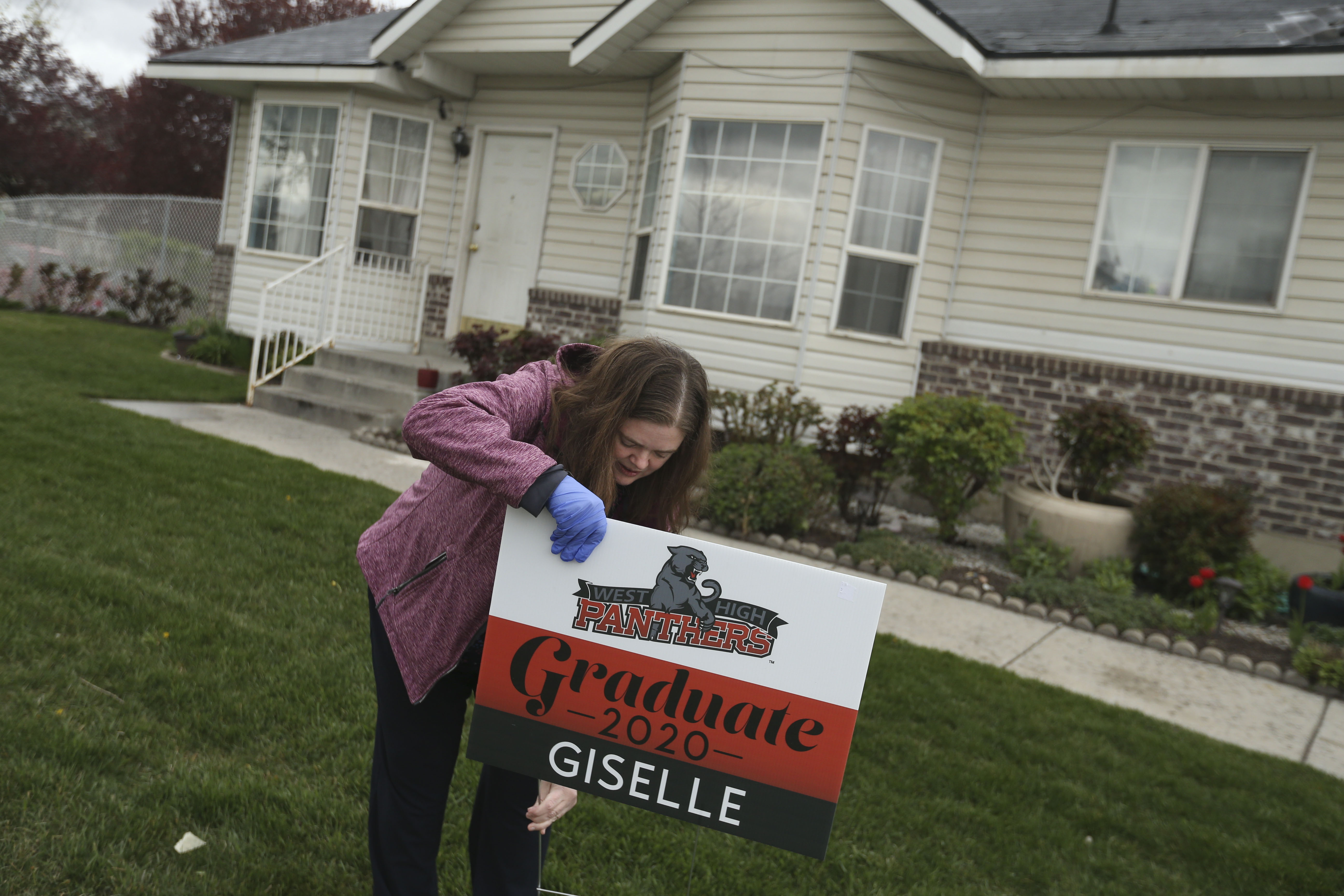 Signs of caring, recognition: West High teachers deliver yard signs to graduating seniors