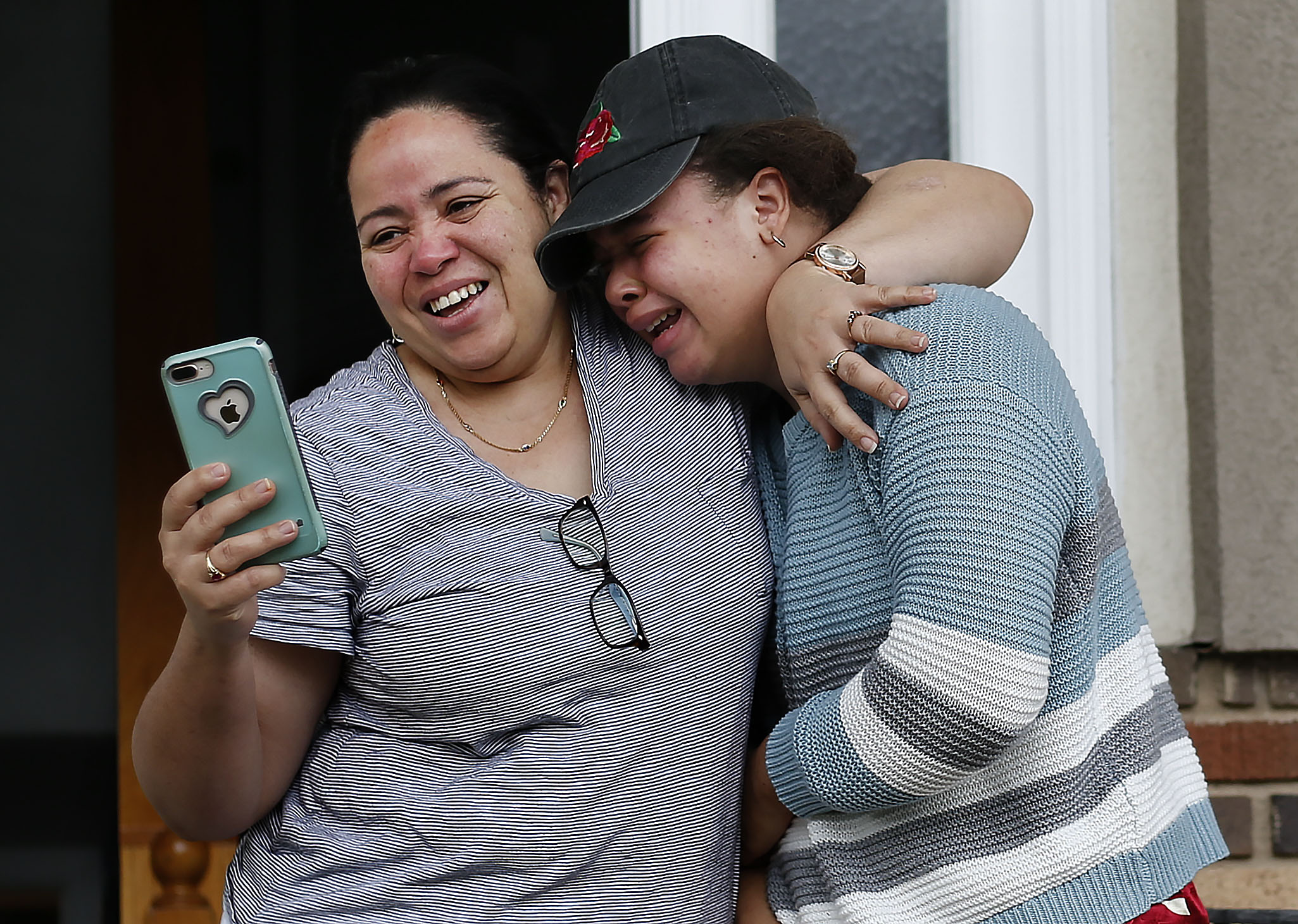 Celeste Carmona consoles her daughter, Lismer, while thanking West High School teacher Kathy Barnard for a yard sign celebrating Lismer's graduation in Salt Lake City on Thursday, April 23, 2020. Lismer said she is disappointed in not having a “normal” ending to her four years of high school. (Laura Seitz, KSL)