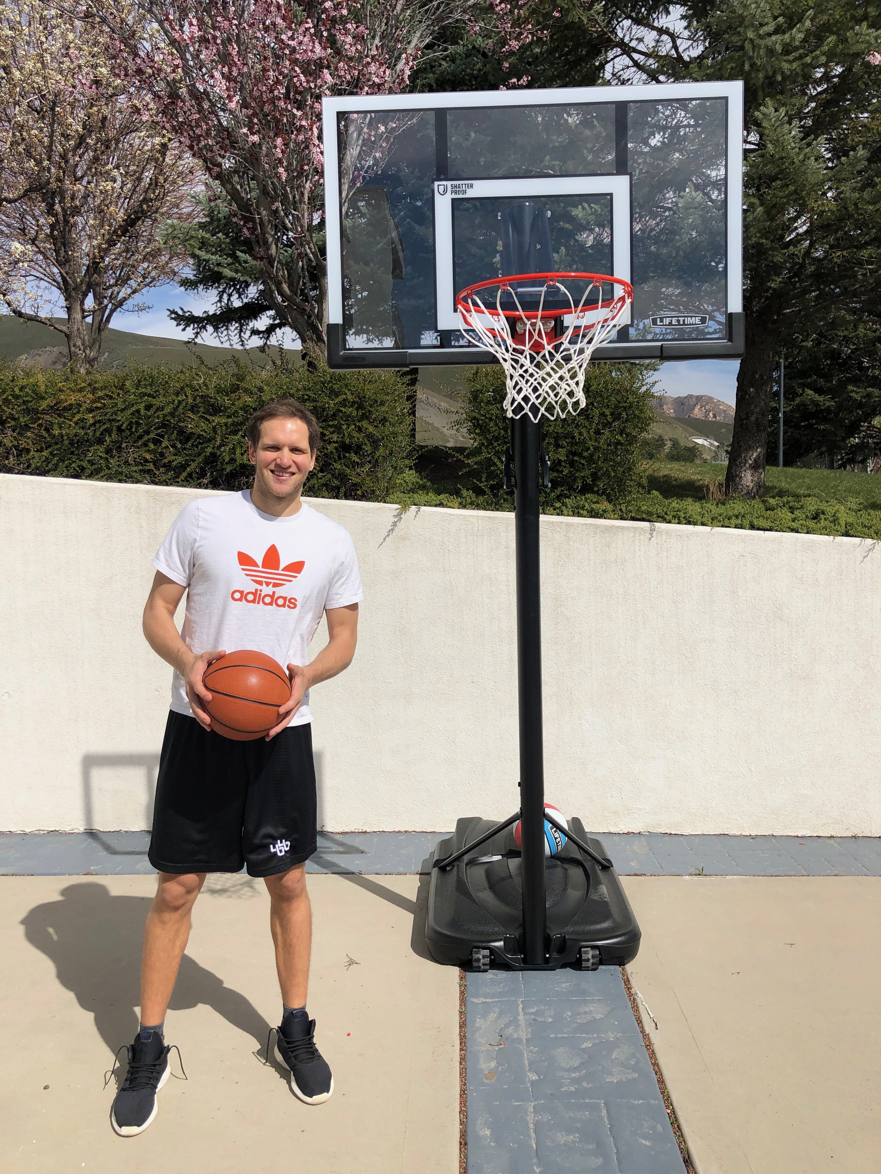 Bojan Bogdanovic stands next to his Lifetime hoop. (Courtesy of Landon Southwick)