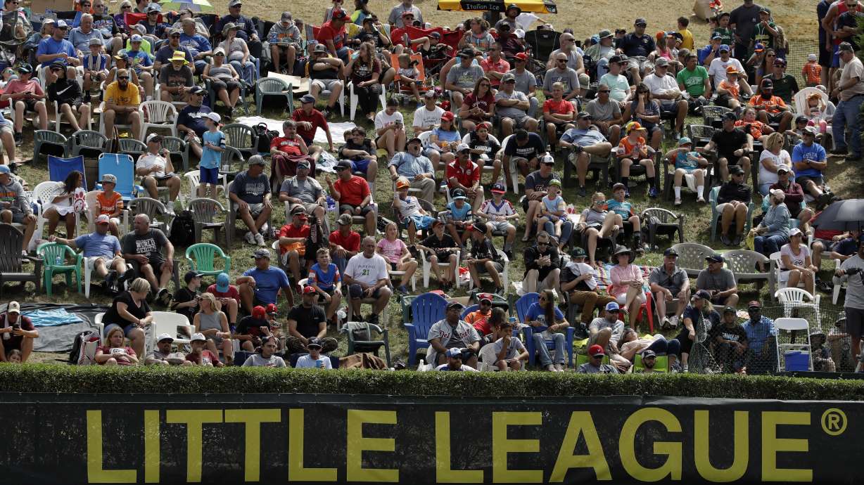 In this Aug. 24, 2019, photo, Little League fans watch from the hillside overlooking left field at Lamade Stadium at the Little League World Series tournament in South Williamsport, Pa. Little League has been benched. The Snow Canyon Little League U-12 All-Stars became the first team from Utah to advance to the LLWS with a 7-3 win over Nevada in the Mountain regional championship.