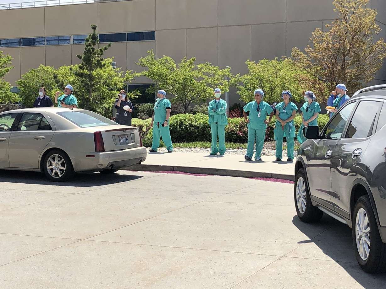Intermountain Health Care staff stand outside the hospital in Murray to watch Hill Air Force Base’s 388th Fighter Wing team fly over on Thursday, April 30, 2020. (Photo: Alex Cabrero, KSL TV)