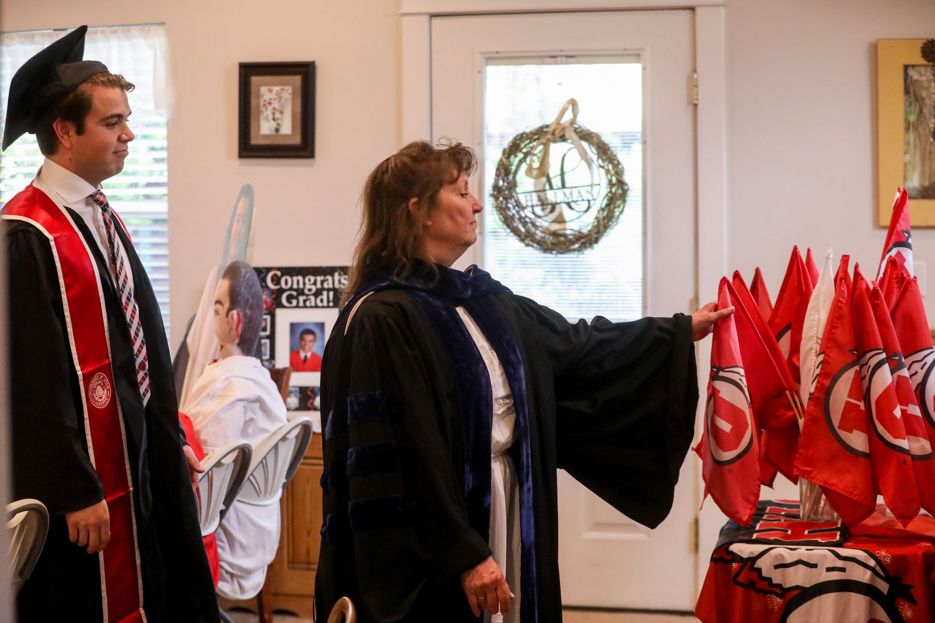 Anita Hallman leads her son Joseph Hallman in a march following his mock commencement ceremony in their Sugar House home amid the COVID-19 pandemic on Thursday, April 30, 2020. The University of Utah grad earned bachelor’s degrees in Latin American studies, Spanish and international business with an emphasis in trade commerce in 2019 with hopes of walking during the spring 2020 commencement ceremony. (Ivy Ceballo, KSL)