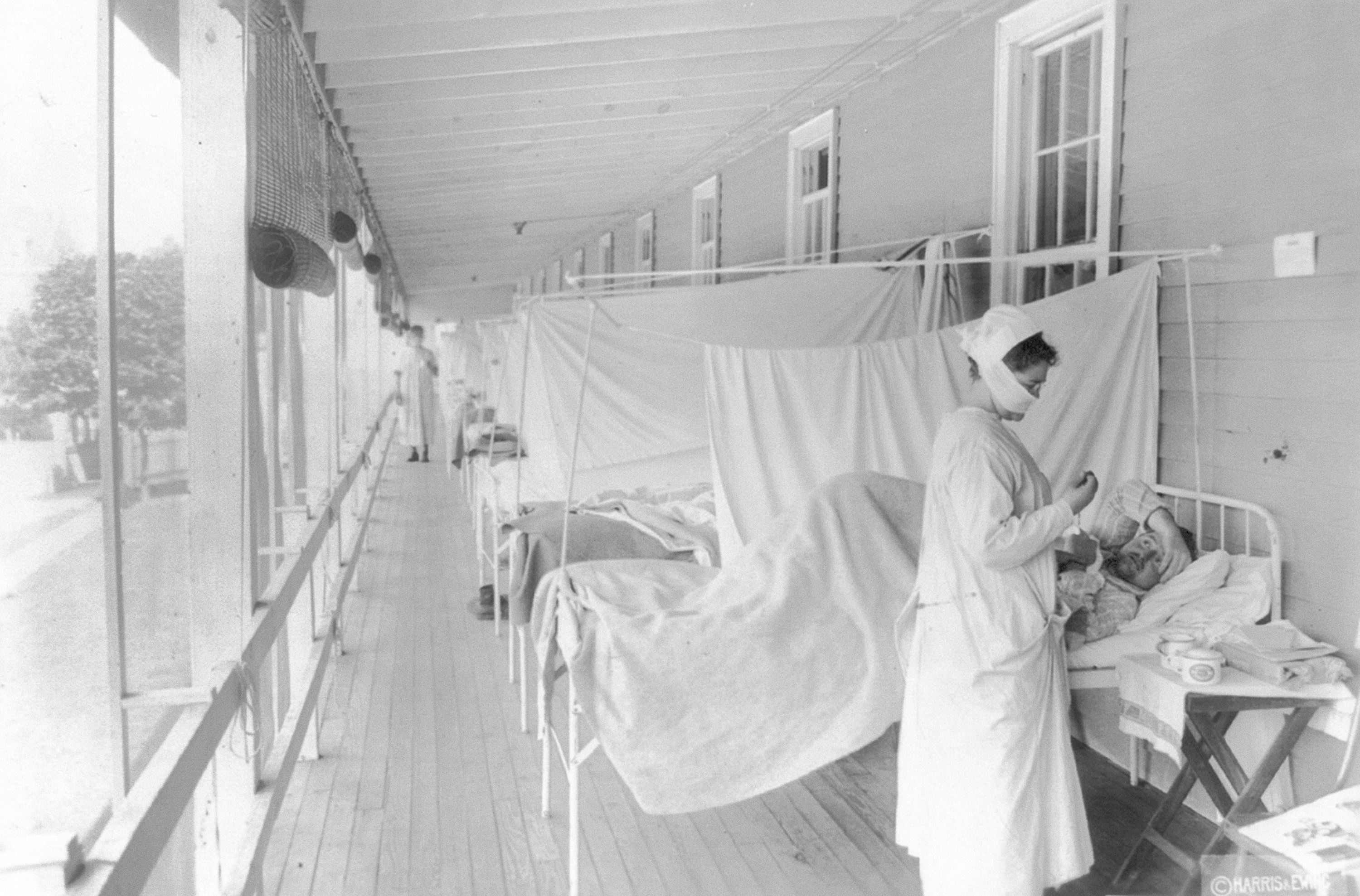 FILE - In this November 1918 photo made available by the Library of Congress, a nurse takes the pulse of a patient in the influenza ward of the Walter Reed hospital in Washington. (Photo: Harris & Ewing/Library of Congress via AP, File)