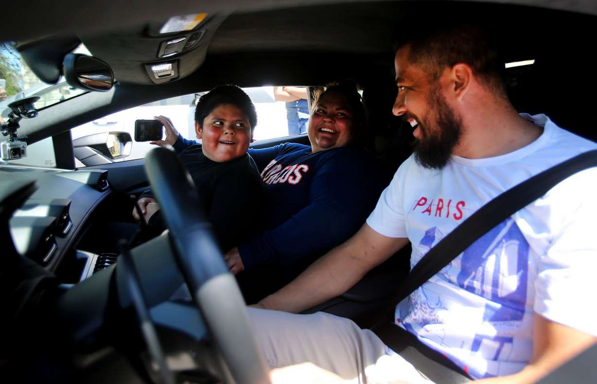 Adrian Zamarripa smiles at Jeremy Neves, owner of a Lamborghini Huracan, after Adrian and his mother, Beatriz Flores, went for a ride in Ogden on Tuesday, May 5, 2020, in Ogden. (Photo: Scott G Winterton, KSL)