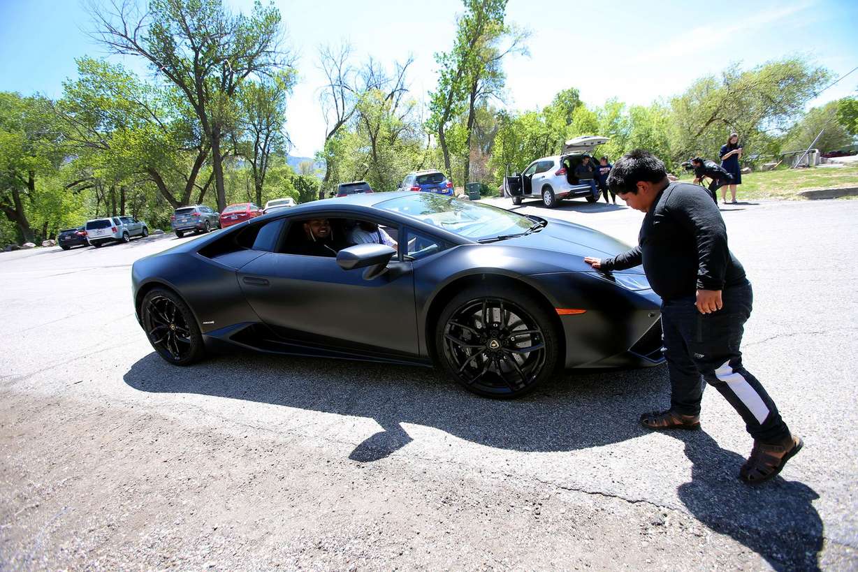 Adrian Zamarripa gently touches the front of Jeremy Neves’ Lamborghini Huracan in Ogden on Tuesday, May 5, 2020. (Photo: Scott G Winterton, KSL)