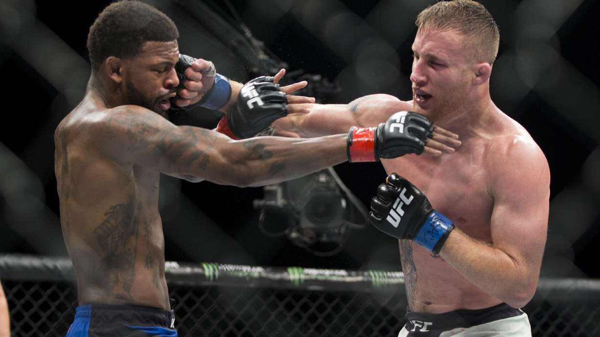 In this July 7, 2017, file photo, Michael Johnson, left, is hit by Justin Gaethje in a UFC lightweight mixed martial arts bout in Las Vegas. Gaethje and Tony Ferguson will headline the mixed martial arts card at UFC 249 behind closed doors at Veterans Memorial Arena in Jacksonville, Fla., Saturday, May 9, 2020.