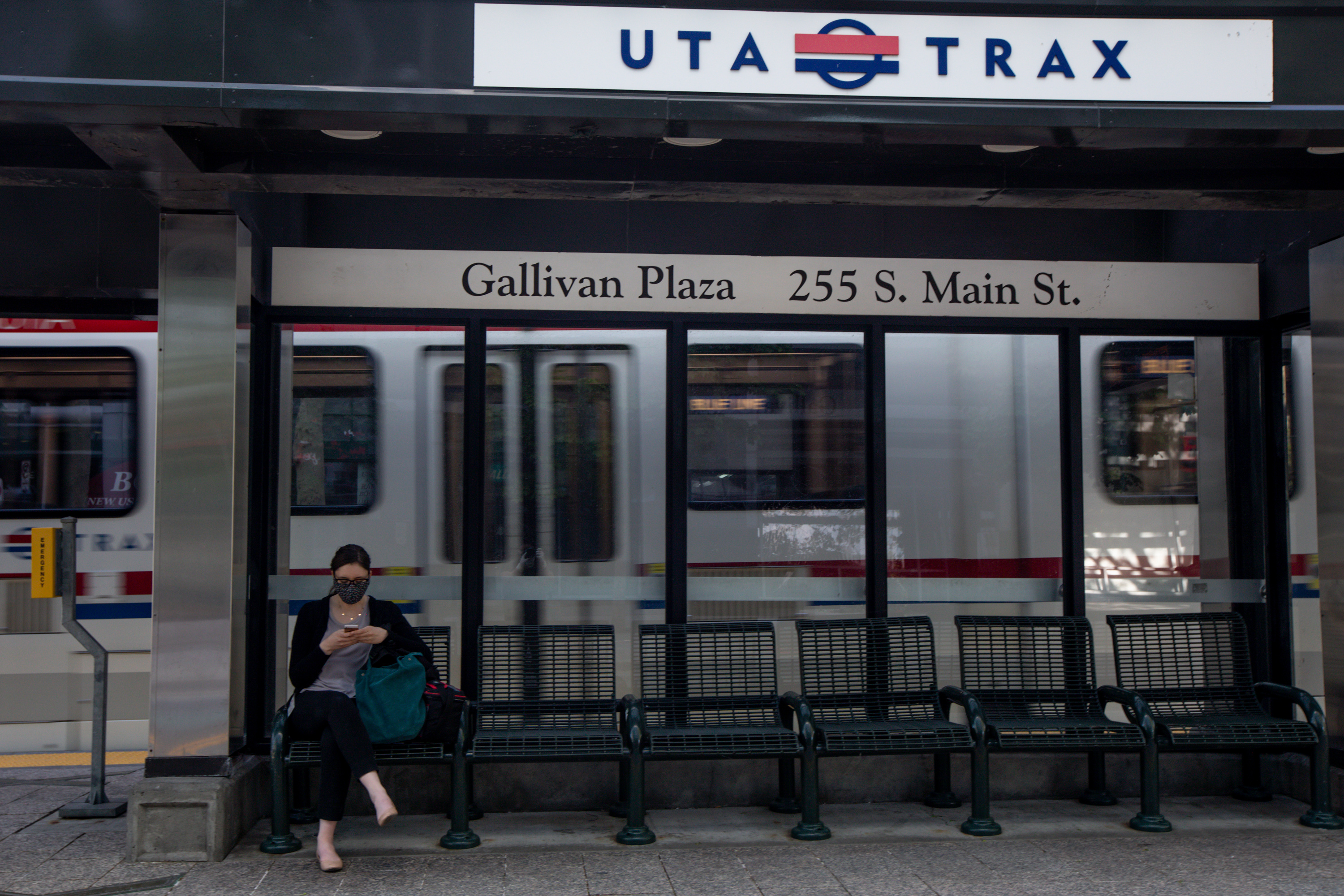 Christine Altamirano reads a novel on her phone while waiting for a TRAX train in downtown Salt Lake City on Thursday, May 7, 2020. (Photo: Ivy Ceballo, KSL)