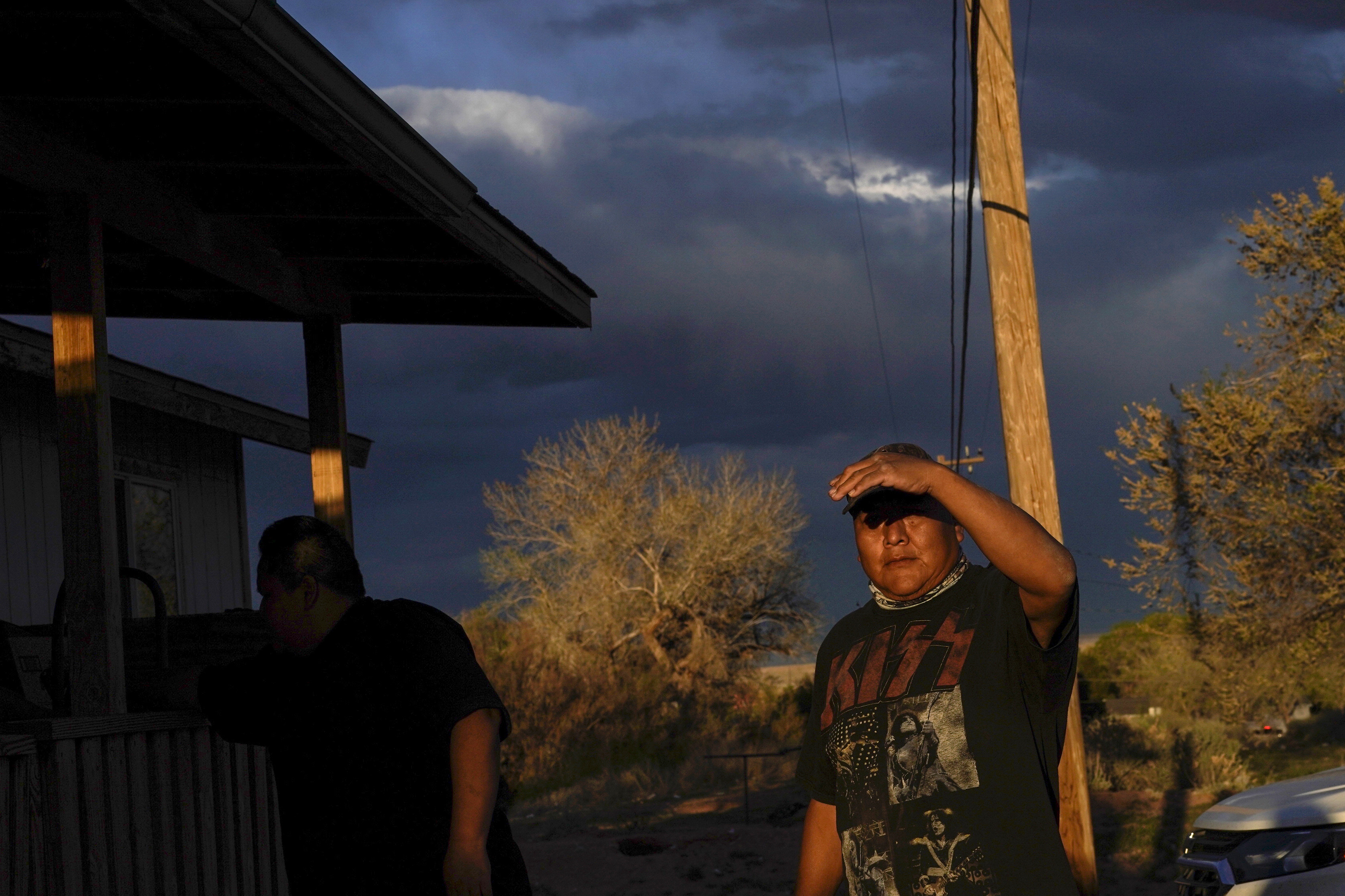 Eugene Dinehdeal shields his face from the setting sun on the Dinehdeal family compound in Tuba City, Ariz., on the Navajo reservation on April 20, 2020. (Carolyn Kaster, AP Photo)