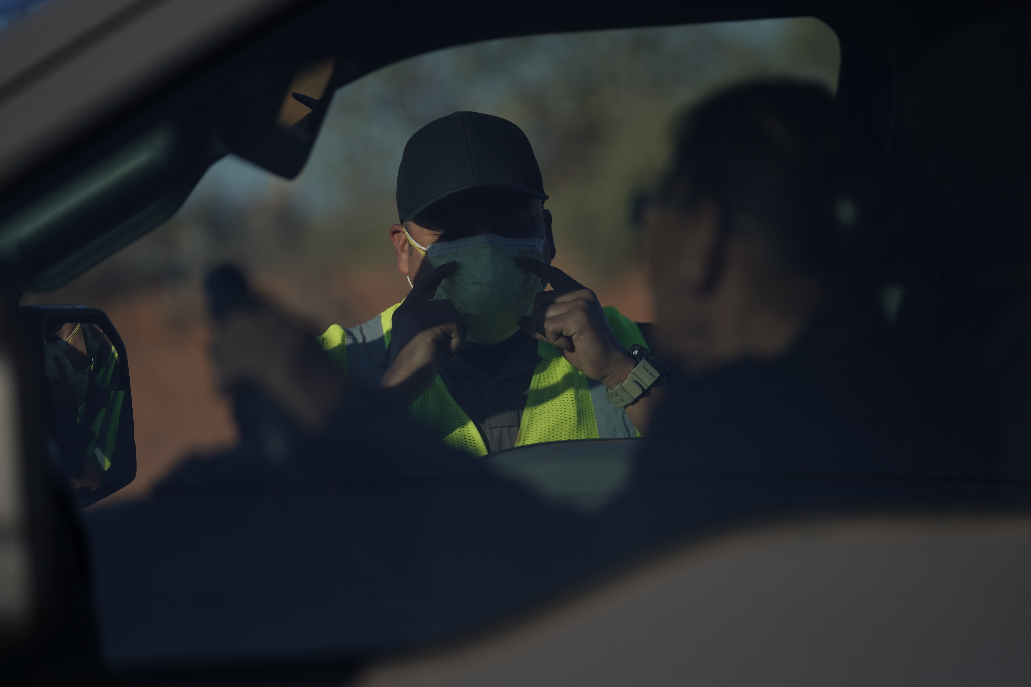 An officer with the Navajo Nation Police talks to a driver at a roadblock in Tuba City, Ariz., on the Navajo reservation on April 22, 2020. The roadblock was to inform residents of evening and weekend curfews, hand washing, and wearing a face mask to help control the spread of COVID-19. (Carolyn Kaster, AP Photo)