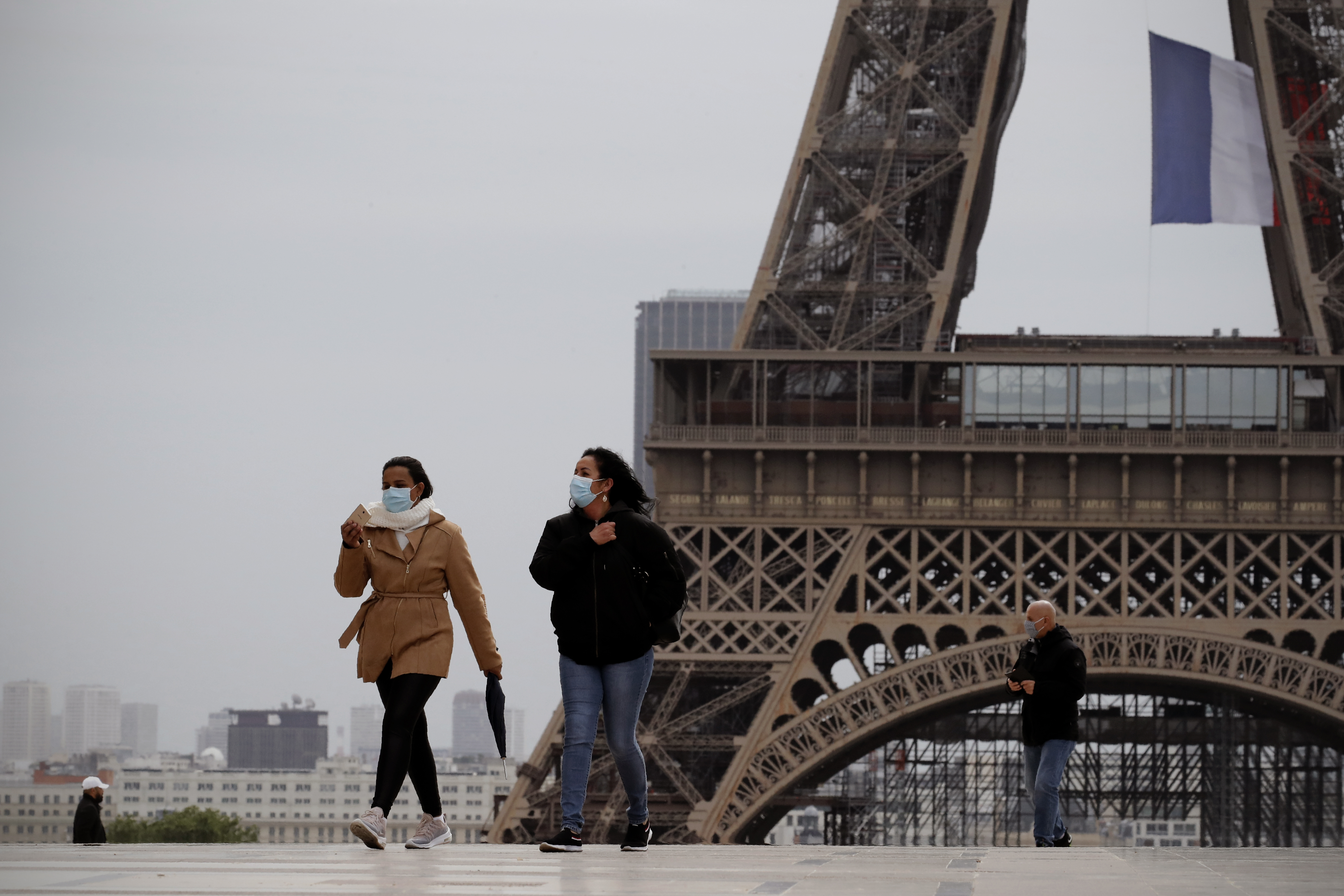 People walk near the Eiffel Tower, in Paris, Monday, May 11, 2020. (Photo: Christophe Ena, AP Photo)
