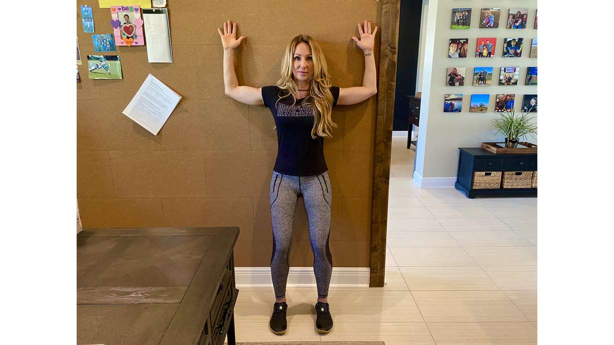 Wall Angels, also known as scapula (shoulder blade) wall slides work to strengthen your back muscles to counteract the overactive muscles in the front of your body that pull you into a slouched position while seated (Photo: Courtesy of Dana Santas)