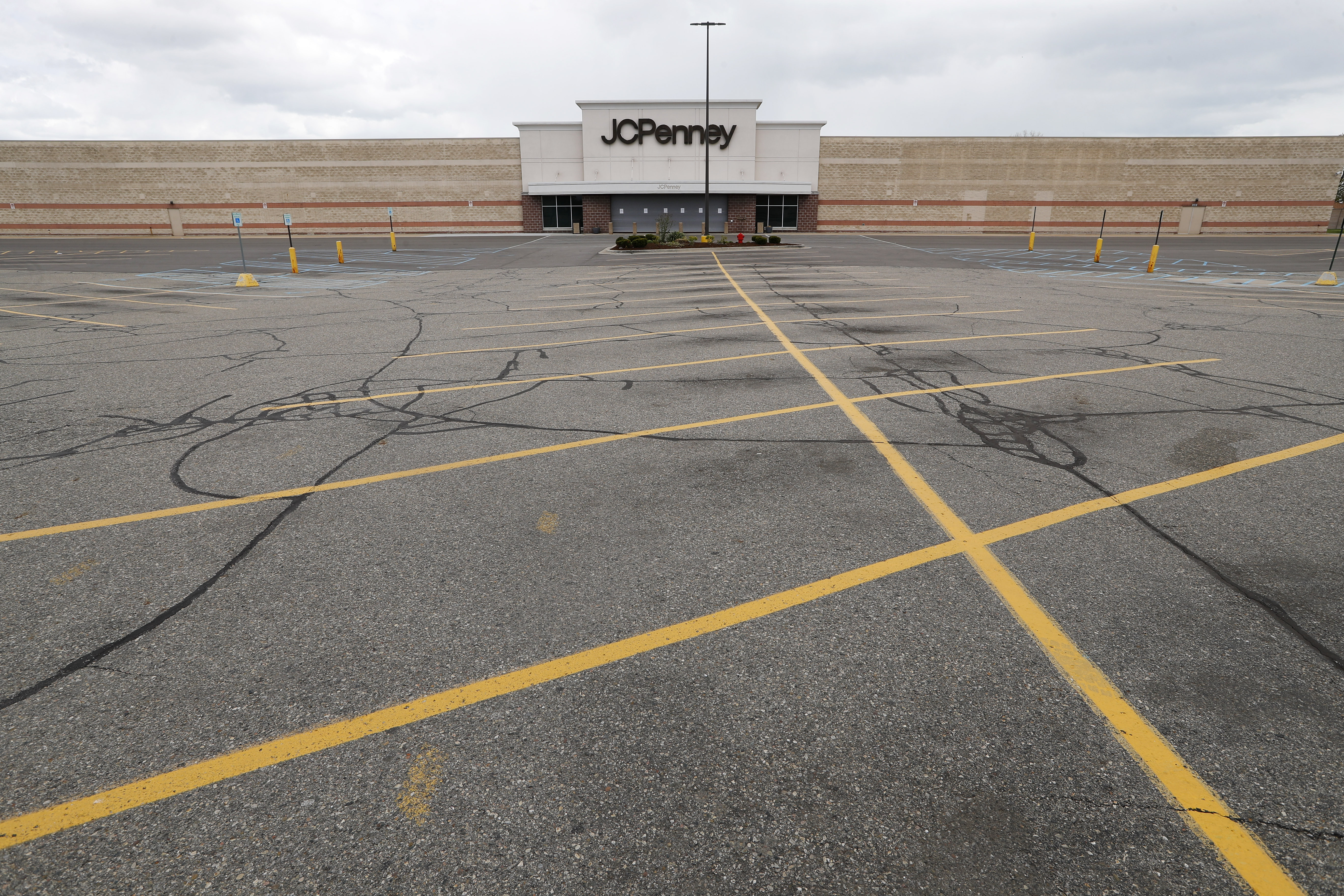 FILE - This May 8, 2020 file photo shows an empty parking lot at a JC Penney store in Roseville, Mich. U.S. retail sales tumbled 16.4% from March to April as business shutdowns caused by the coronavirus kept shoppers away, threatened stores across the country and weighed down a sinking economy. (Paul Sancya, AP Photo File)