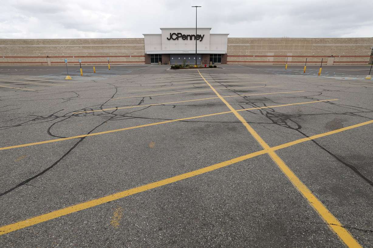 FILE - This May 8, 2020 file photo shows an empty parking lot at a JC Penney store in Roseville, Mich. U.S. retail sales tumbled 16.4% from March to April as business shutdowns caused by the coronavirus kept shoppers away, threatened stores across the country and weighed down a sinking economy. (Paul Sancya, AP Photo File)