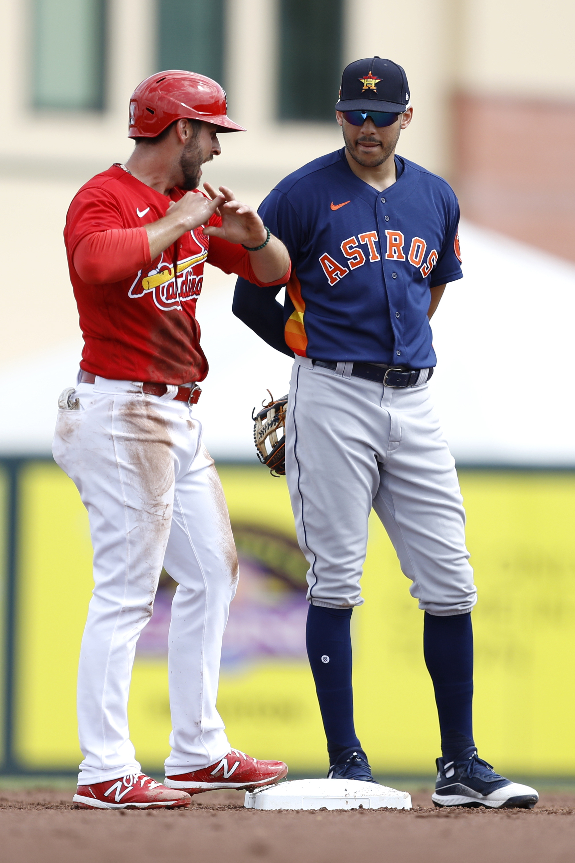 In this March 3, 2020, file photo, St. Louis Cardinals' Paul DeJong, left, talks to Houston Astros shortstop Carlos Correa during the second inning of a spring training baseball game in Jupiter, Fla. The exchange of lineup cards would be eliminated, fielders will be encourages to space themselves from baserunners between pitches and managers and coaches must wear masks while in the dugouts under Major League Baseball's proposed operations manual for starting the coronavirus-delayed season. (Photo: Julio Cortez, AP Photo, File)