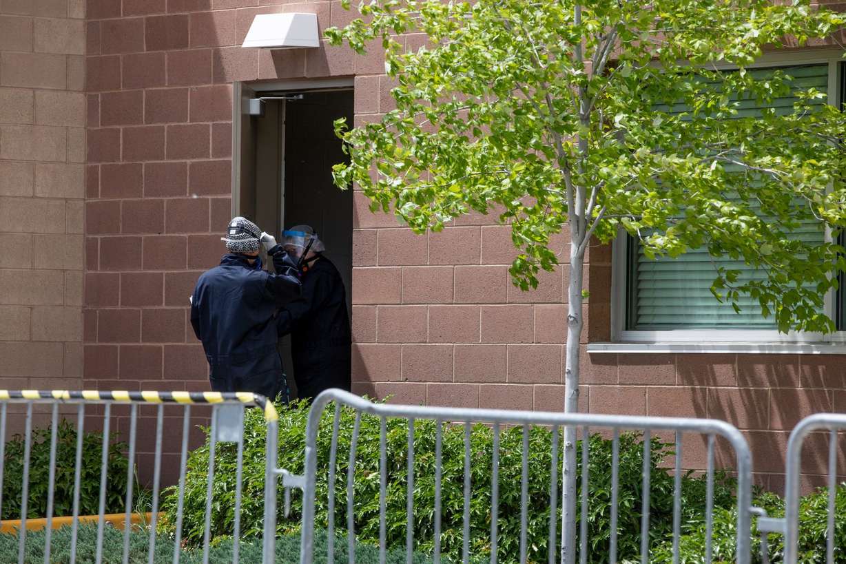 Workers in a hazmat suits stand at a barricaded doorway inside the Holladay Lions Recreation Center in Millcreek on Monday, May 18, 2020. (Photo: Ivy Ceballo, KSL)