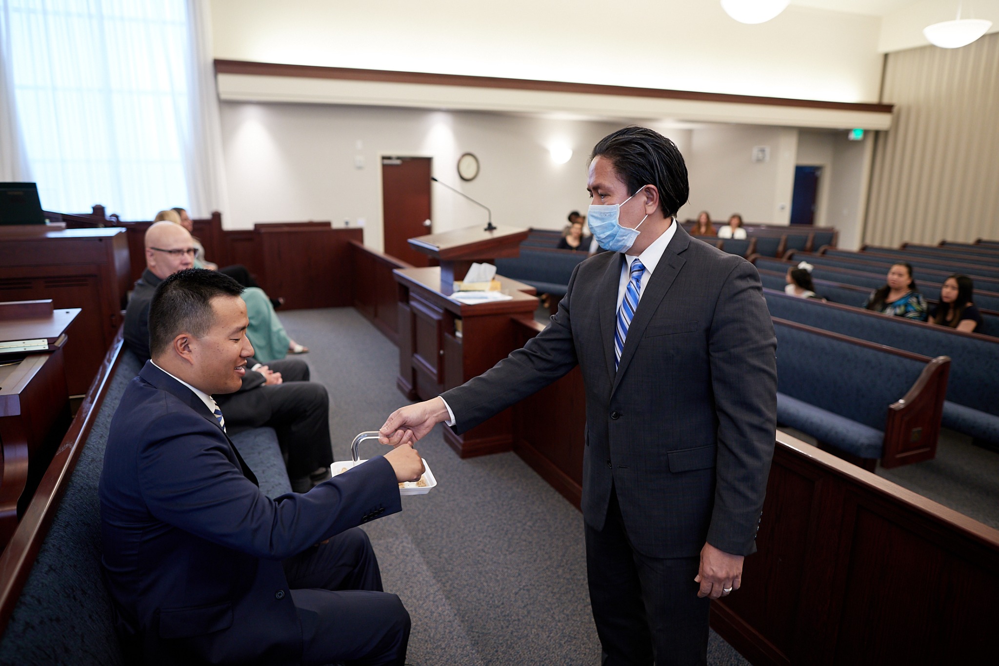 A Latter-day Saint priesthood holder wears a mask as he passes the sacrament during a sacrament meeting. Church meetings are scheduled to resume in phases in some areas of the world this weekend with pandemic-related precautions. (The Church of Jesus Christ of Latter-day Saints)