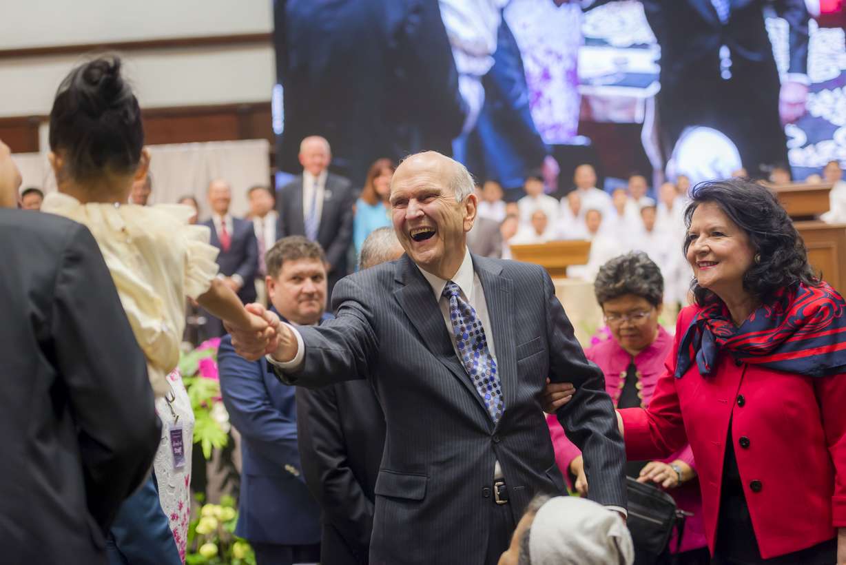 President Russell M. Nelson shakes the hand of a young girl during a gathering in Bangkok, Thailand, April 20, 2018.