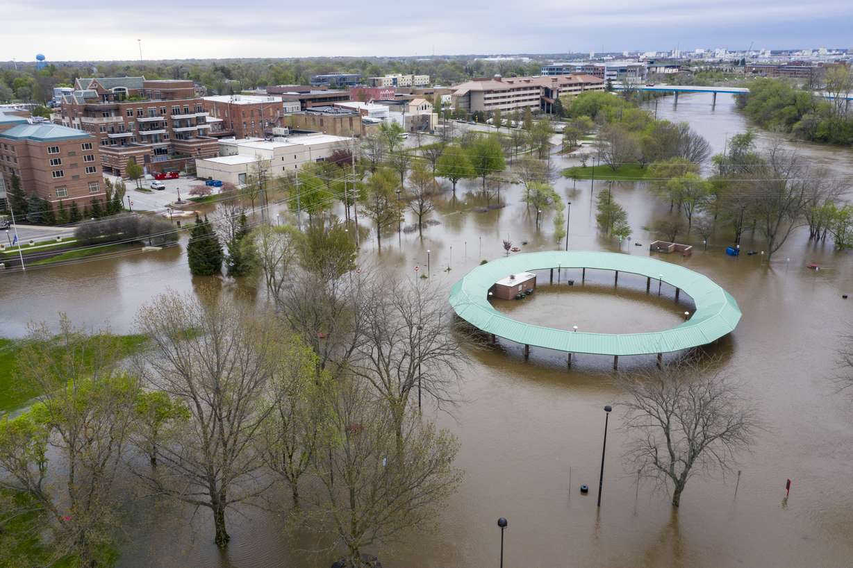 Water floods the Midland Area Farmers Market and the bridge along the Tittabawassee River in Midland, Mich. on Tuesday, May 19, 2020. (Kaytie Boomer, MLive.com, The Bay City Times via AP)
