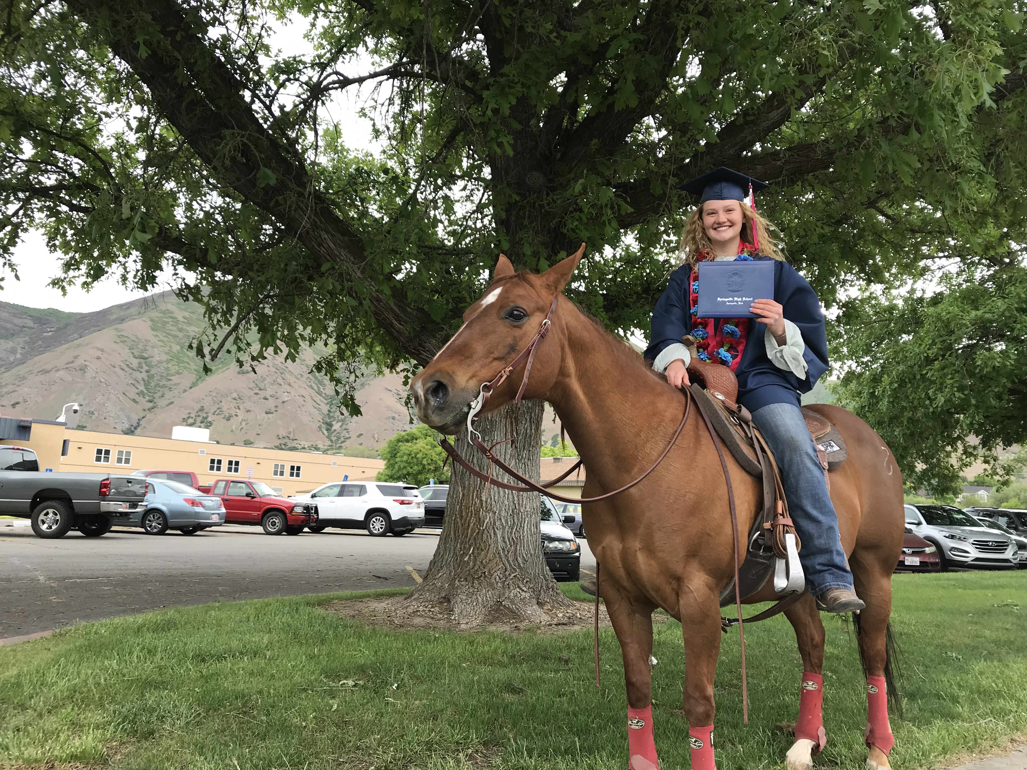 Springville senior Alli Johansen holds her diploma with her horse Ginger during a drive-thru graduation parade to honor the Class of 2020, Wednesday, May 20, 2020 in Springville, Utah. (Photo: Sean Walker, KSL.com)