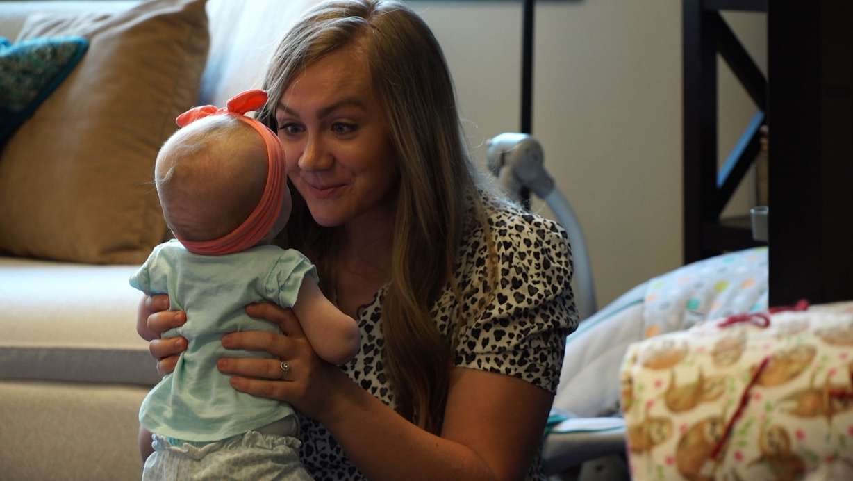 Jordan Coburn plays with her little 4-month-old baby, Penny. (KSL TV)