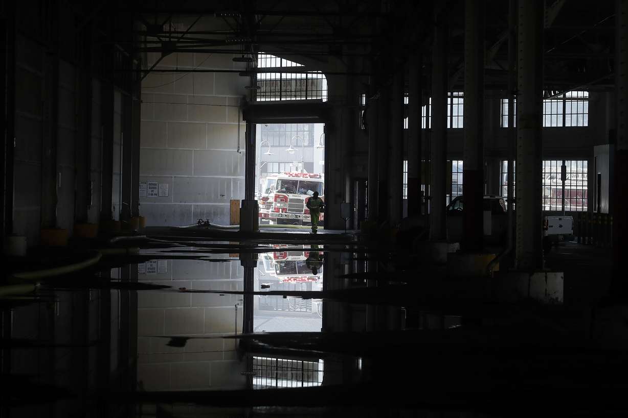 A fire official is shown reflected in a puddle in a warehouse after a fire broke out before dawn at Fisherman's Wharf in San Francisco, Saturday, May 23, 2020. Fire officials said no injuries have been reported Saturday morning and firefighters are making multiple searches to ensure no one was inside the building on Pier 45. (Photo: Jeff Chiu, AP Photo)
