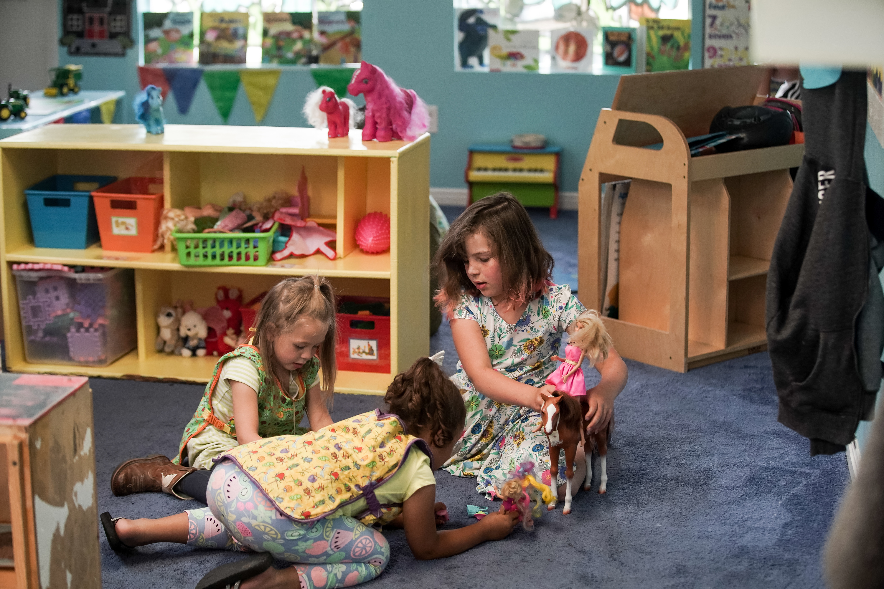 Blakelynn Adams, 4, Makaia Taylor, 6, and Lilly Virga, 7, play together at Sunshine Academy Preschool & Daycare in Alpine on Thursday, May 14, 2020. Sunshine Academy is one of several child care centers that have been approved to reopen, with a number of strict new operating guidelines, to serve the children of essential workers during the COVID-19 pandemic. (Photo: Spenser Heaps, KSL)
