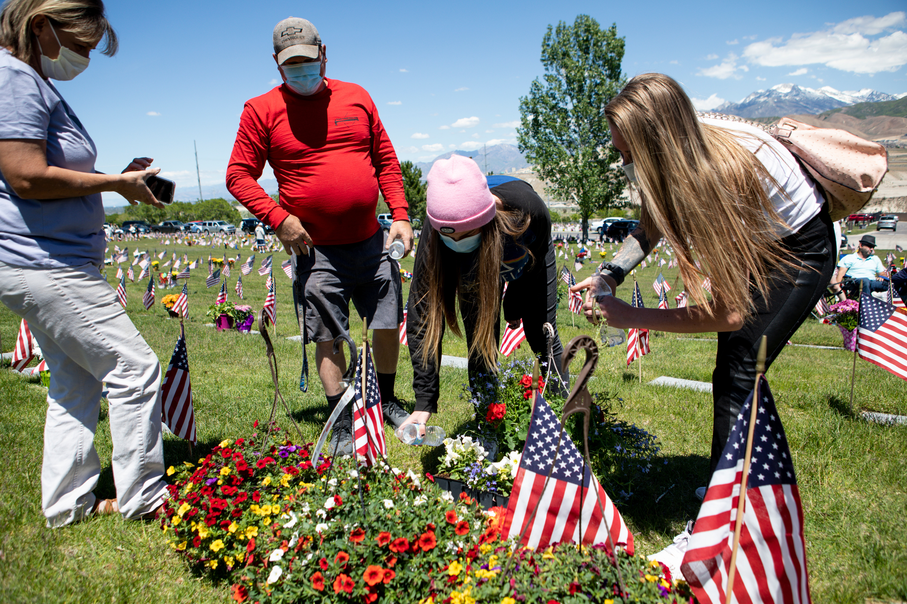 Sidney Paiz, Donald Franklin, Grace Franklin and Oakley Franklin wear masks as they water flowers on their son and brother’s gravesite at Utah Veterans Cemetery and Memorial Park in Bluffdale on Memorial Day, Monday, May 25, 2020. (Photo: Ivy Ceballo, KSL)