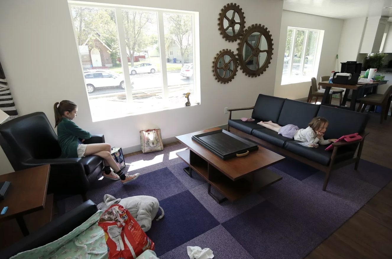 Flo and Lillie Thomas-Watson sit inside a highly efficient electric home their mother helped build in Ogden on Tuesday, May 19, 2020. WSU faculty and students have spent the last year working with the city of Ogden to create a highly efficient 100% electric home as part of a competition hosted by the Department of Energy. (Photo: Jeffrey D. Allred, KSL.)