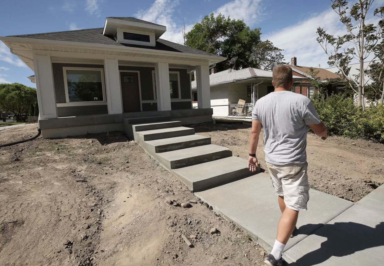 Weber State Professor Jeremy Farner walks up to a highly efficient electric home he’s worked on in Ogden on Tuesday, May 19, 2020. WSU faculty and students have spent the last year working with the city of Ogden to create a highly efficient 100% electric home as part of a competition hosted by the Department of Energy. (Photo: Jeffrey D. Allred, KSL.)