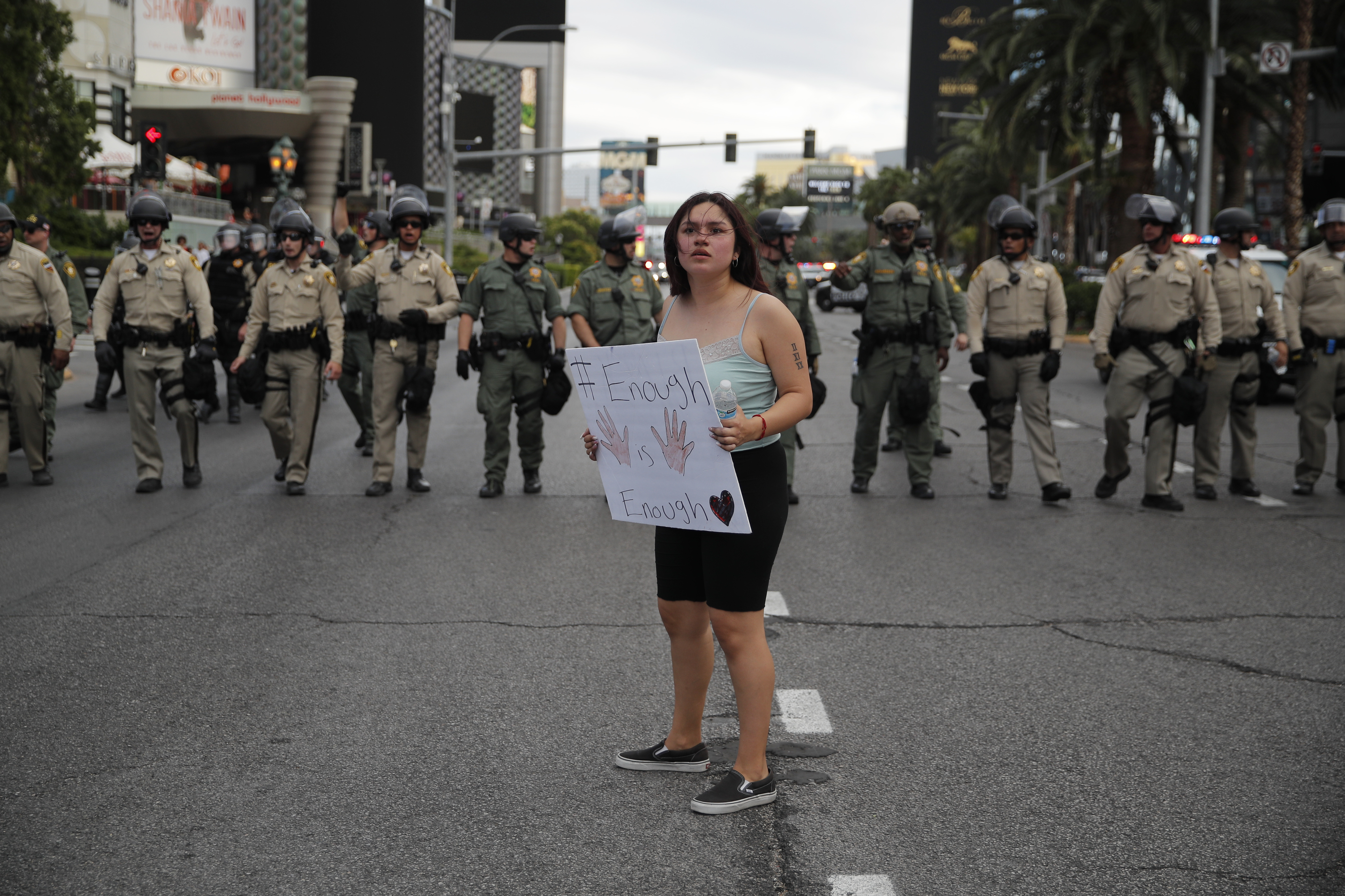 A woman protesting the death of George Floyd stands in front of a line of police along Las Vegas Boulevard, Friday, May 29, 2020, in Las Vegas. Floyd died on Memorial Day while in the custody of the Minneapolis police. (Photo: John Locher, AP Photo)