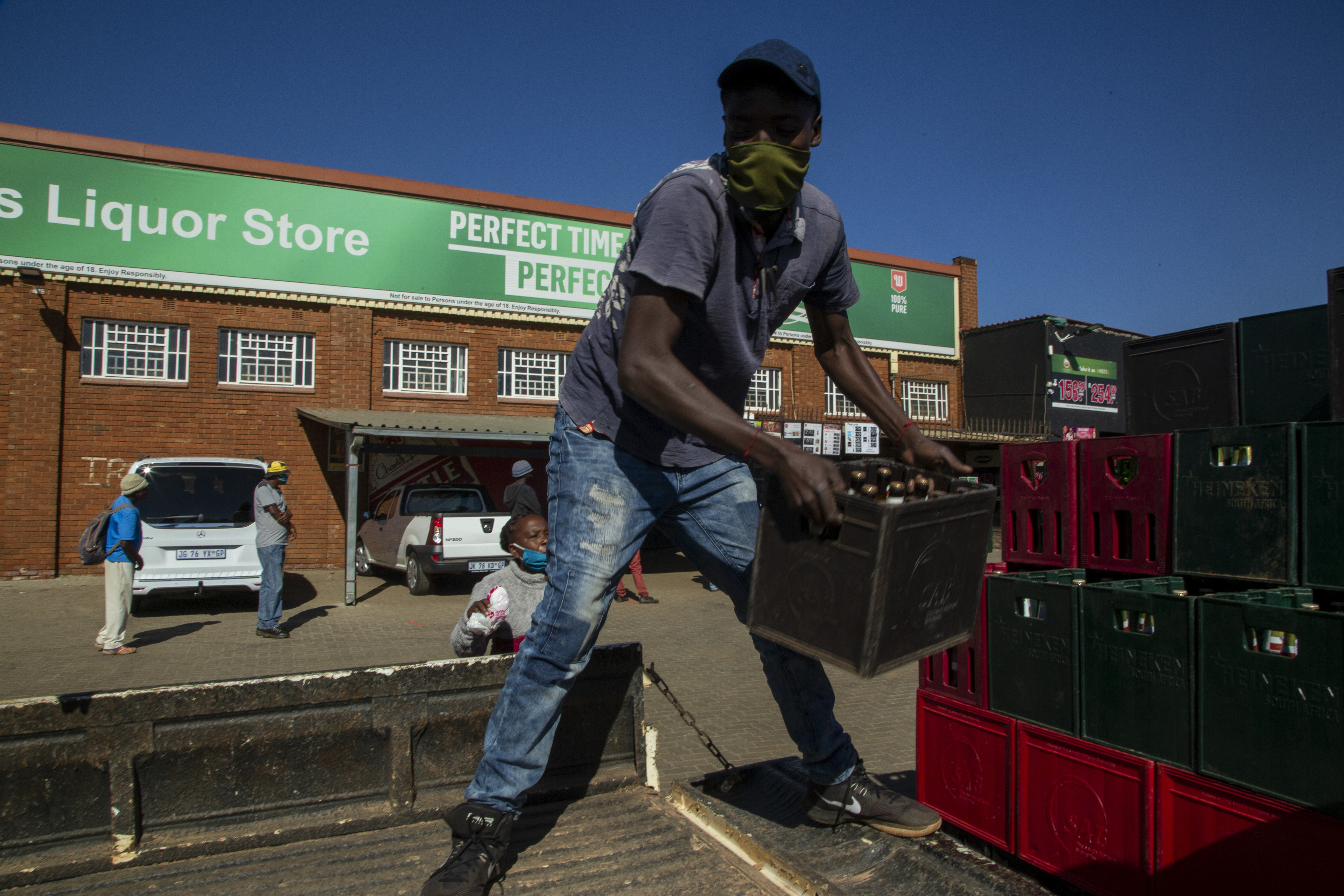 South Africa eases; liquor is sold, school openings delayed