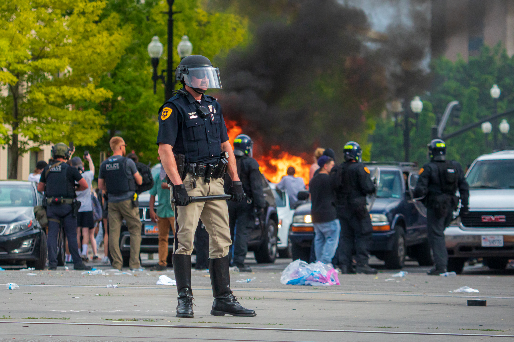 A police officer stands in the street near Library Square in Salt Lake City as a car burns in the background during a protest that turned into a riot on Saturday, May 30, 2020. (Photo: Carter Williams, KSL.com, File)