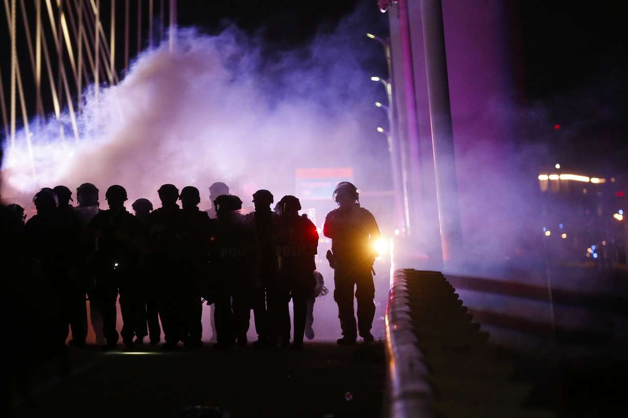 Police deploy smoke bombs and tear gas as they surround protesters who marched onto the Margaret Hunt Hill Bridge while demonstrating against police brutality on Monday, June 1, 2020, in Dallas. (Photo: Ryan Michalesko/The Dallas Morning News via AP)