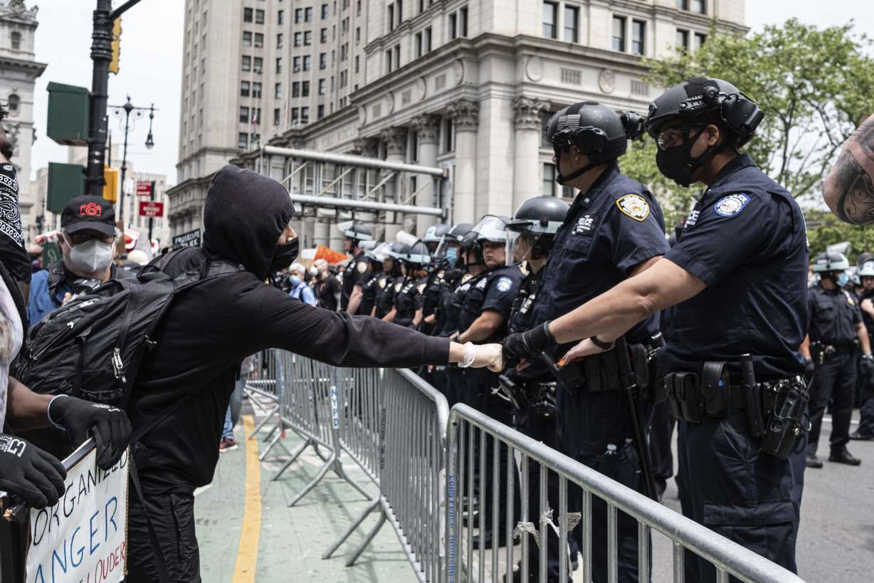 In this photo taken with a wide angle lens, demonstrators stand in front of Los Angeles City Hall during a protest over the death of George Floyd Tuesday, June 2, 2020, in Los Angeles. Floyd died in police custody on Memorial Day in Minneapolis. (Mark J. Terrill, AP Photo)