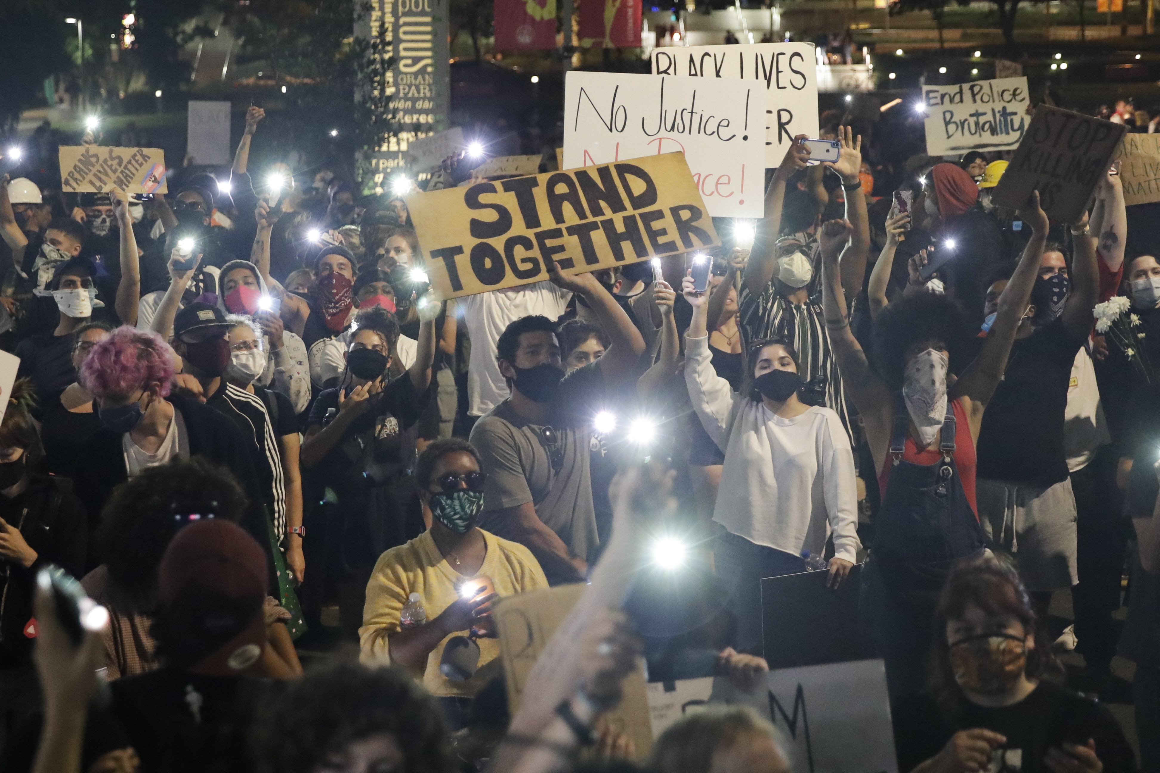 Demonstrators use their phone lights Wednesday, June 3, 2020 in downtown Los Angeles during a protest over the death of George Floyd who died May 25 after he was restrained by Minneapolis police. (Marcio Jose Sanchez, AP Photo)