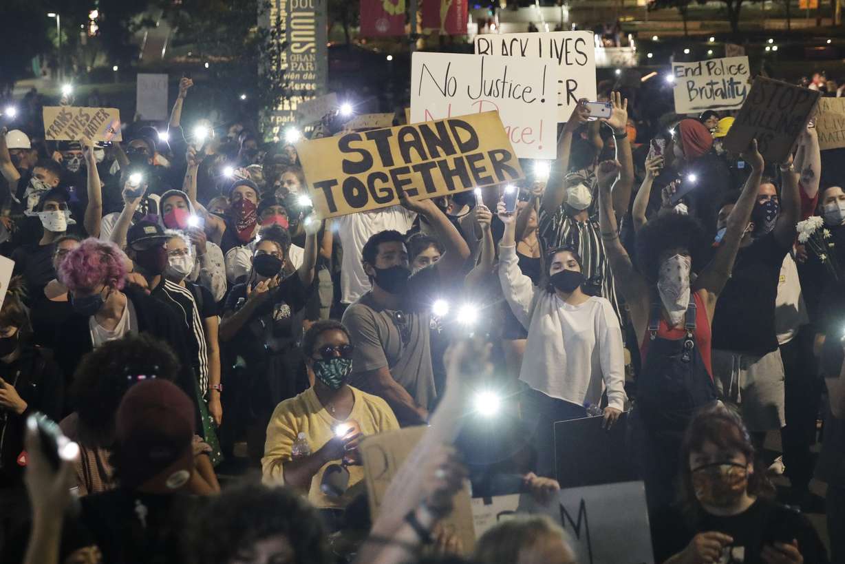 Demonstrators use their phone lights Wednesday, June 3, 2020 in downtown Los Angeles during a protest over the death of George Floyd who died May 25 after he was restrained by Minneapolis police. (Marcio Jose Sanchez, AP Photo)