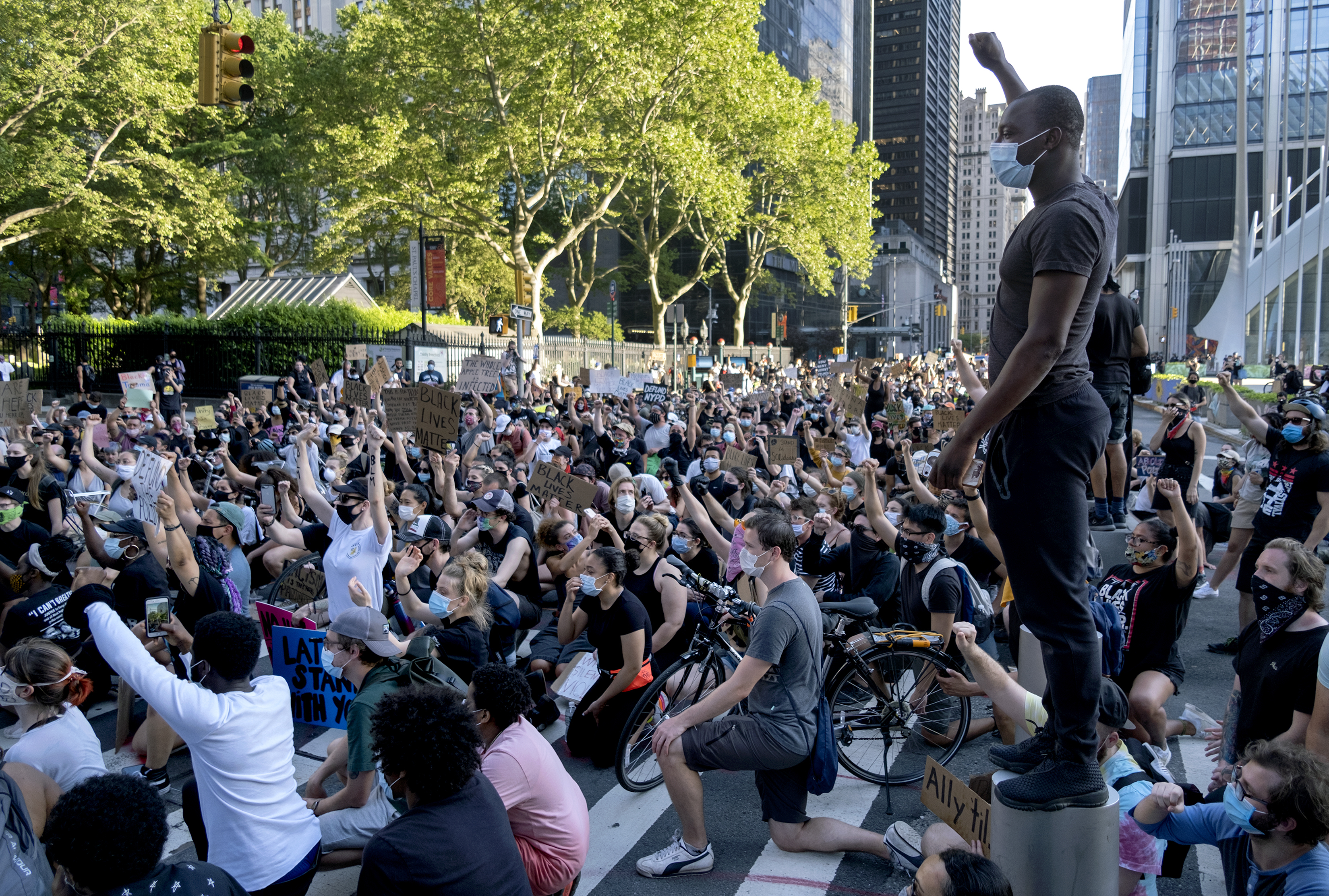 A group of protesters take a knee while marching in lower Manhattan, Saturday, June 6, 2020, in New York. Protests continued following the death of George Floyd, who died after being restrained by Minneapolis police officers on May 25. (AP Photo/Craig Ruttle)