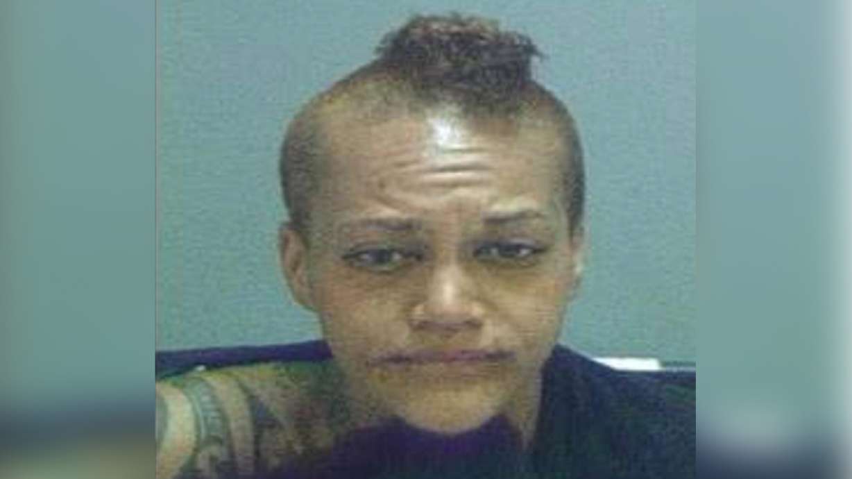 Police arrest woman accused of urinating on overturned Salt Lake patrol car during riot