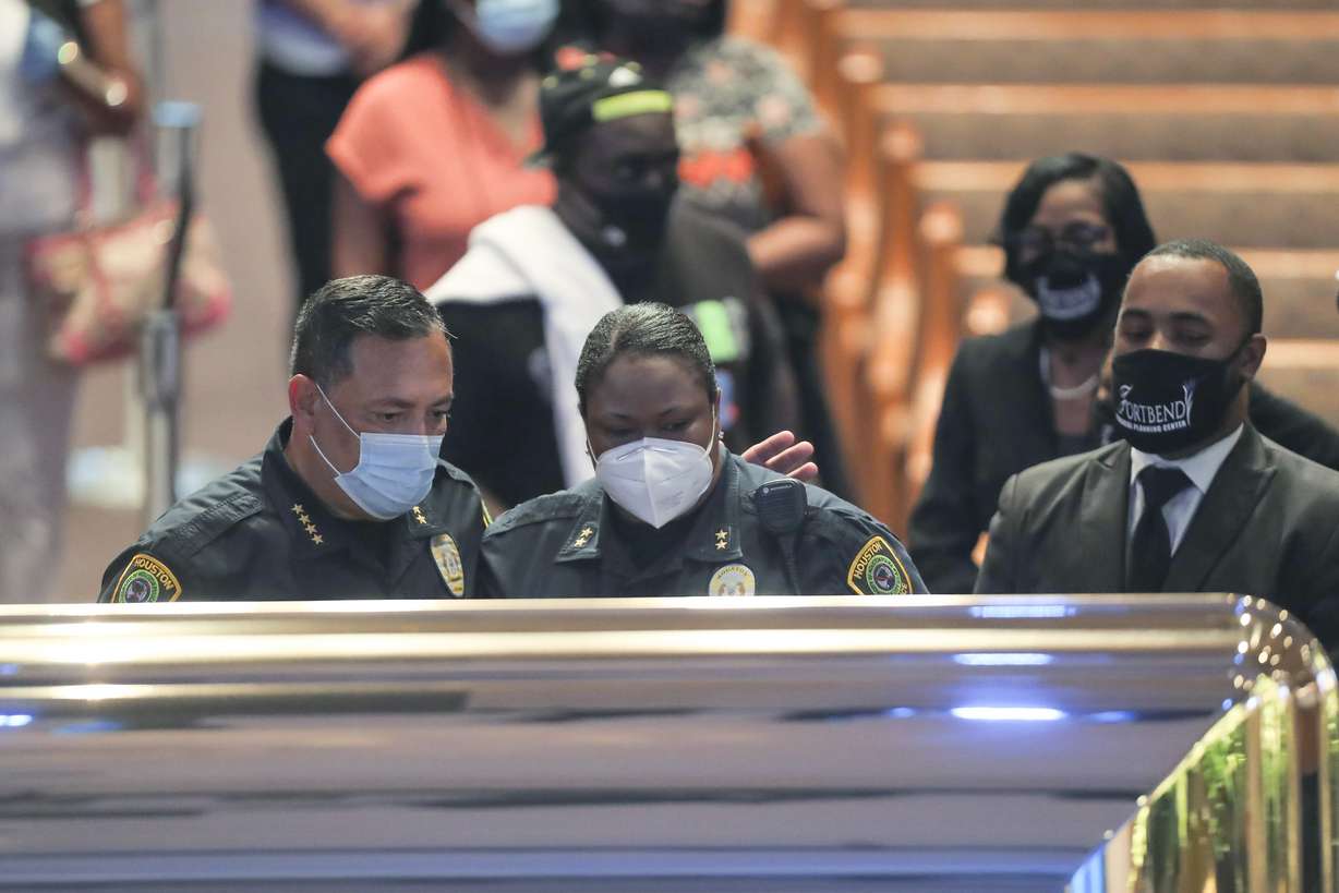 Houston Police Department chief Art Acevedo and assistant chief Sheryl Victorian visit the open casket of George Floyd during a public visitation Monday, June 8, 2020, at The Fountain of Praise church in Houston. (Godofredo A. Vásquez, Houston Chronicle via AP)