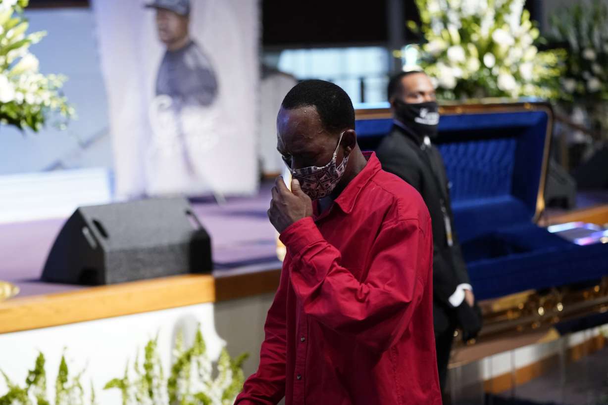 A mourner pass by the casket of George Floyd during a public visitation for Floyd at the Fountain of Praise church Monday, June 8, 2020, in Houston. (David J. Phillip, Pool, AP Photo)