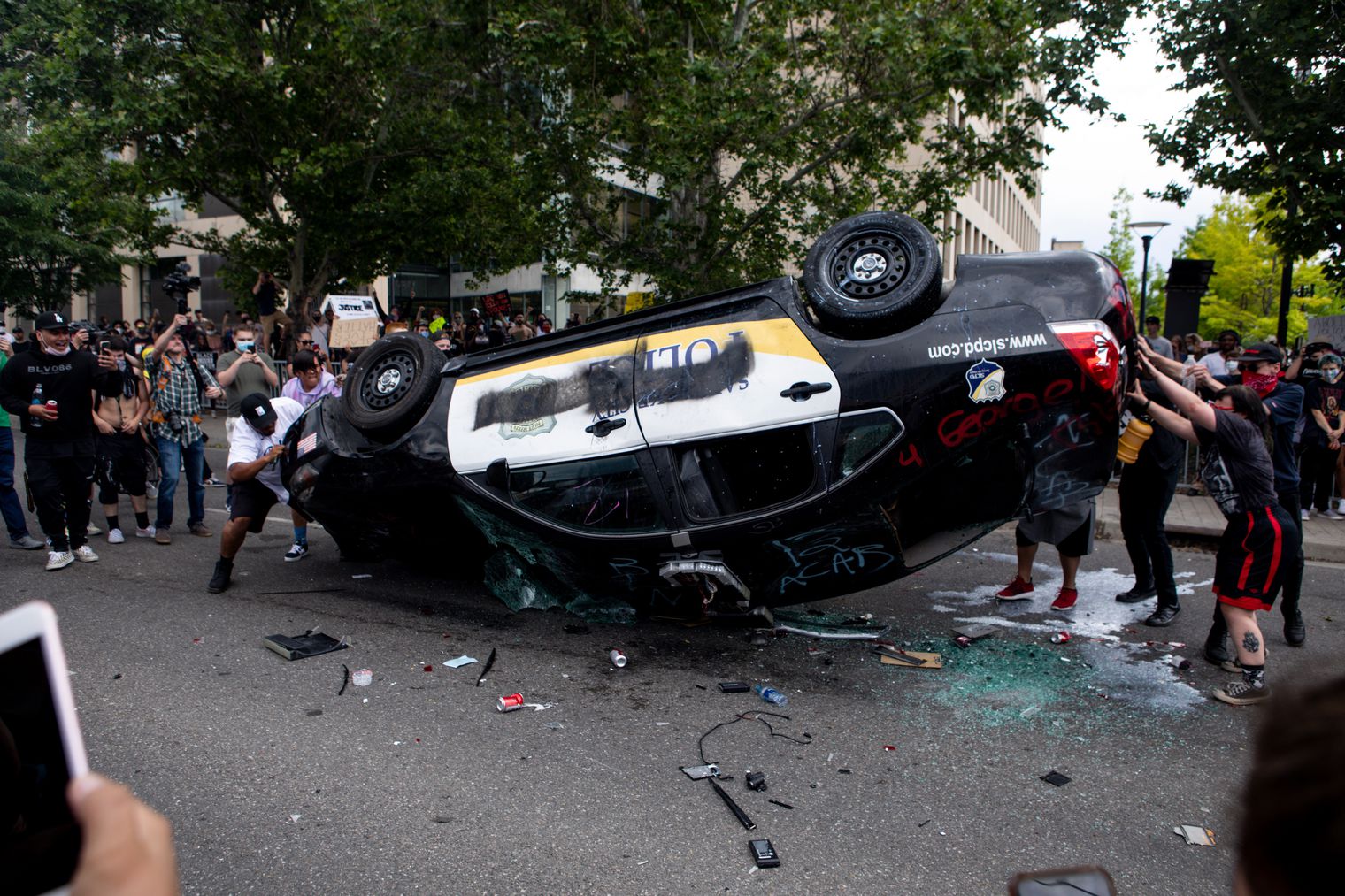 A Salt Lake City Police Department patrol car is overturned during a protest in downtown Salt Lake City on May 30, 2020. A man who admitted to helping overturn and burn the car was sentenced this week to two years in federal prison in the case. 