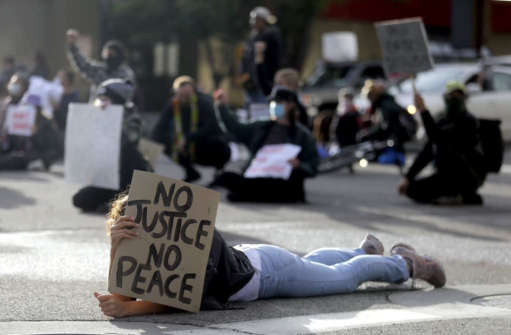 Protesters lie down or take a knee at the intersection of State Street and South Temple to honor those who have been killed as a result of police brutality and to protest racism in Salt Lake City on Monday, June 8, 2020. (Photo: Kristin Murphy, KSL)