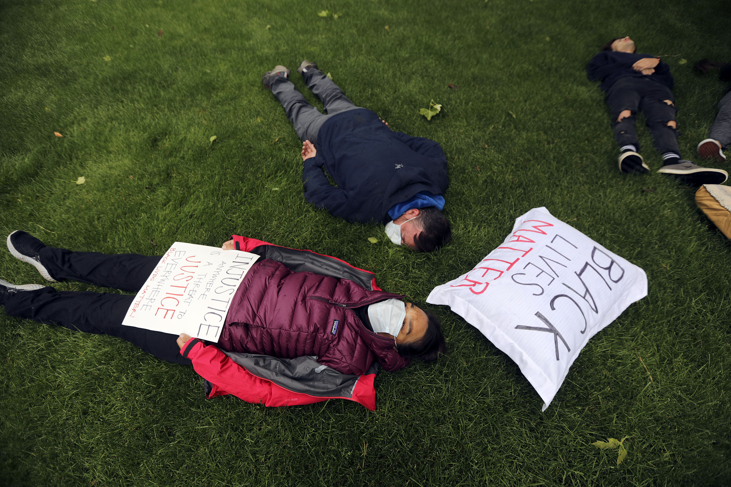 Angie McReaken and Jacob McReaken lie down for 8 minutes and 46 seconds, the time former Minneapolis police officer Derek Chauvin knelt on the neck of George Floyd in May, killing him, during a protest in Washington Square Park in Salt Lake City on Monday, June 8, 2020. (Photo: Kristin Murphy, KSL)