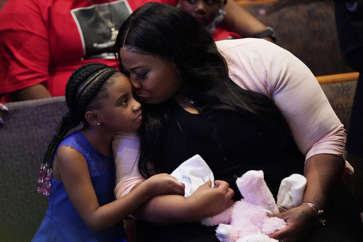 Roxie Washington holds Gianna Floyd, the daughter of George Floyd as they attend the funeral service for George Floyd at The Fountain of Praise church Tuesday, June 9, 2020, in Houston. (David J. Phillip, Pool, AP Photo)