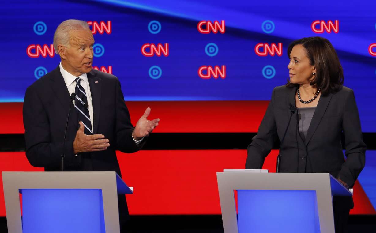FILE - In this July 31, 2019, file photo, then-Democratic presidential candidate Sen. Kamala Harris, D-Calif., listens as Democratic presidential candidate former Vice President Joe Biden speaks during a Democratic presidential primary debate at the Fox Theatre in Detroit.