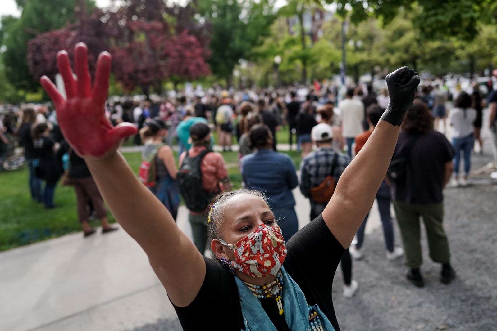 Roberta Huss, who identified herself as a proud Dakota Sioux woman and enrolled member of the Sisseton Tribe, raises her hands while gathering with protesters in Pioneer Park in Salt Lake City on Saturday, June 13, 2020. (Photo: Spenser Heaps, KSL)