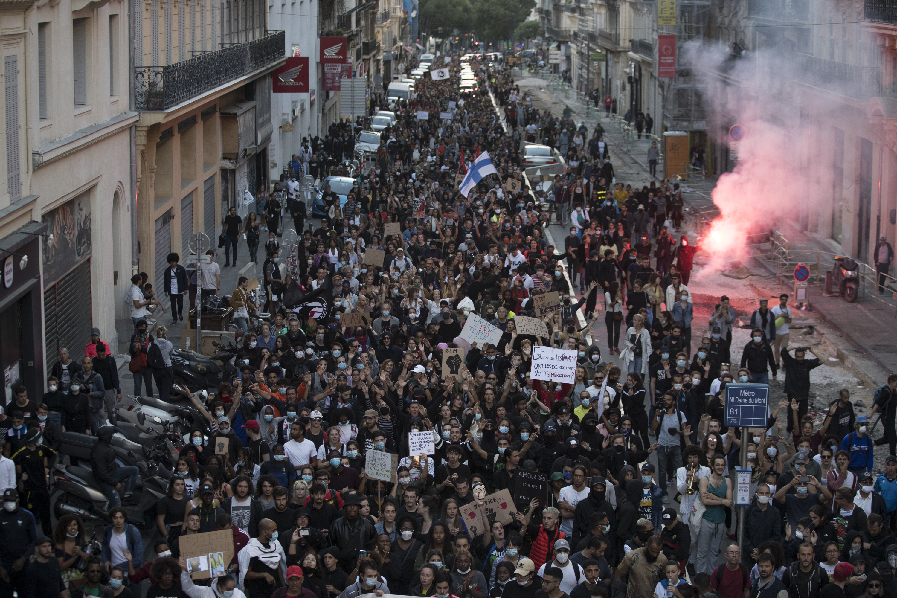 Protesters march against police brutality and racism in Marseille, France, Saturday, June 13, 2020, at a demonstration organized by supporters of Adama Traore, who died in police custody in 2016 in circumstances that remain unclear despite four years of back-and-forth autopsies. (Daniel Cole, AP Photo)