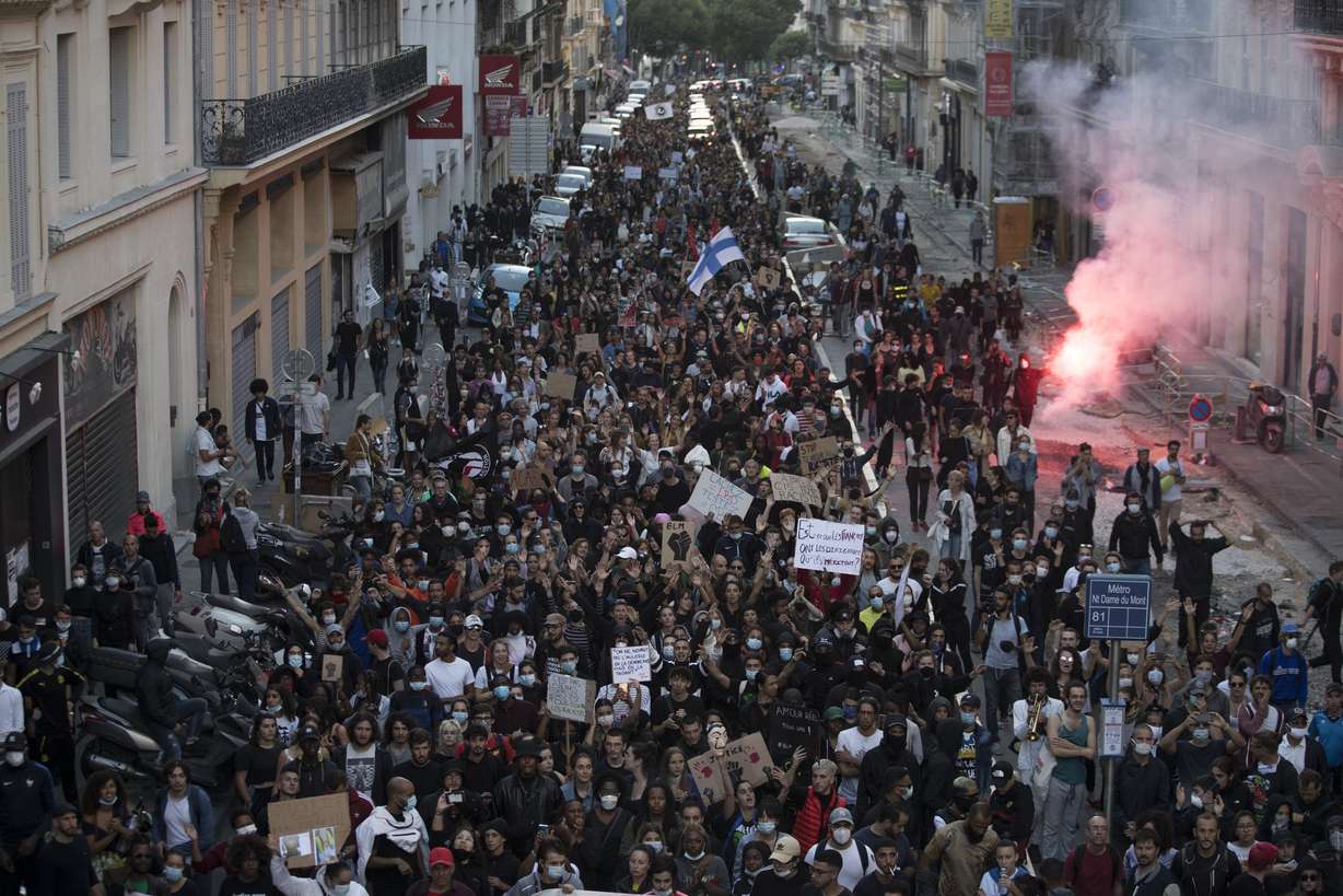 Protesters march against police brutality and racism in Marseille, France, Saturday, June 13, 2020, at a demonstration organized by supporters of Adama Traore, who died in police custody in 2016 in circumstances that remain unclear despite four years of back-and-forth autopsies. (Daniel Cole, AP Photo)