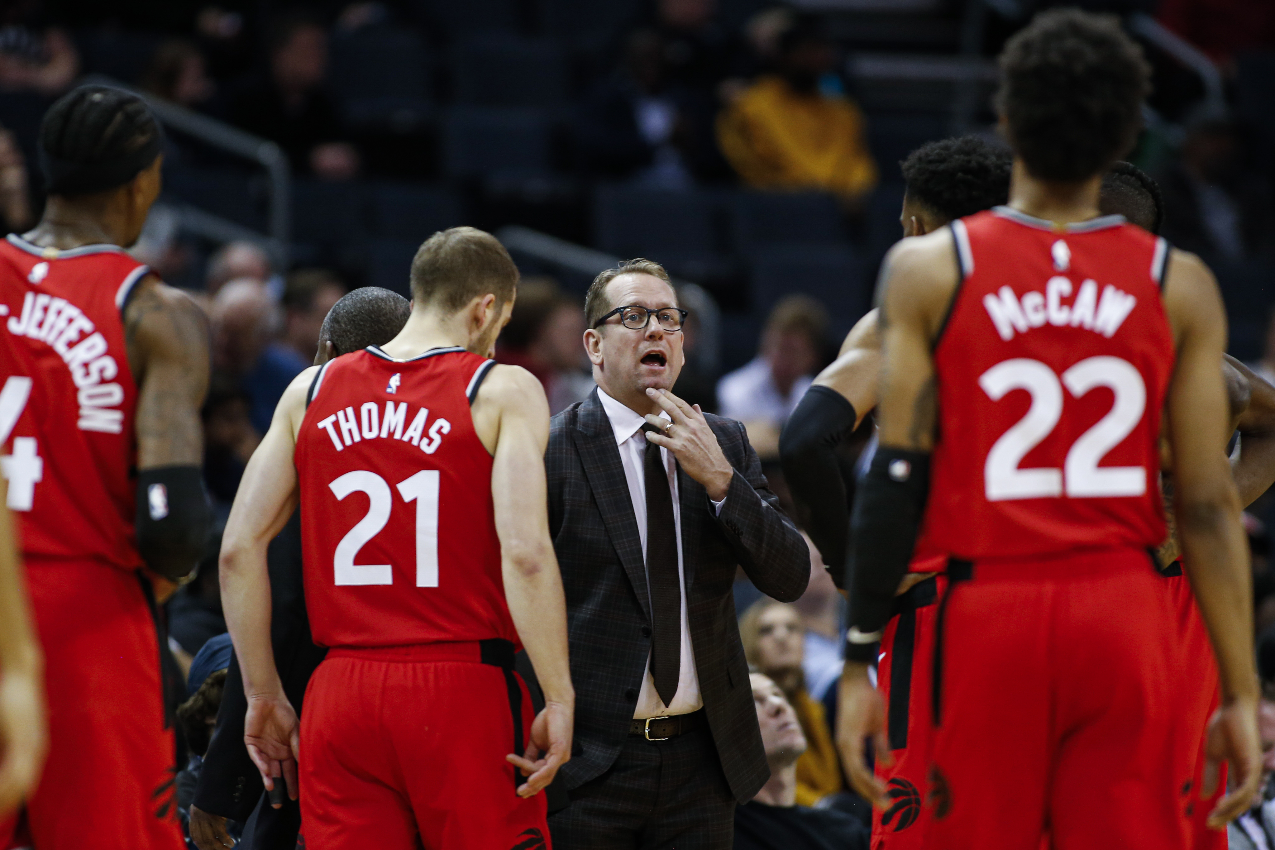 In this Jan. 8, 2020, file photo, Toronto Raptors coach Nick Nurse, center, gathers his team during a timeout in the first half of an NBA basketball game against the Charlotte Hornets in Charlotte, N.C. The Raptors have an NBA championship to defend, a very long stay at the Disney complex awaiting them and plenty of unanswered questions on how the restart of the season will work. As the NBA’s lone Canadian team, there’s an added complexity: The U.S. border. Nurse said Tuesday, June 9, 2020, that his team is still working through various scenarios for having workouts before heading to Disney World near Orlando, Florida along with 21 other teams next month for the restart of the season. (AP Photo/Nell Redmond, File)