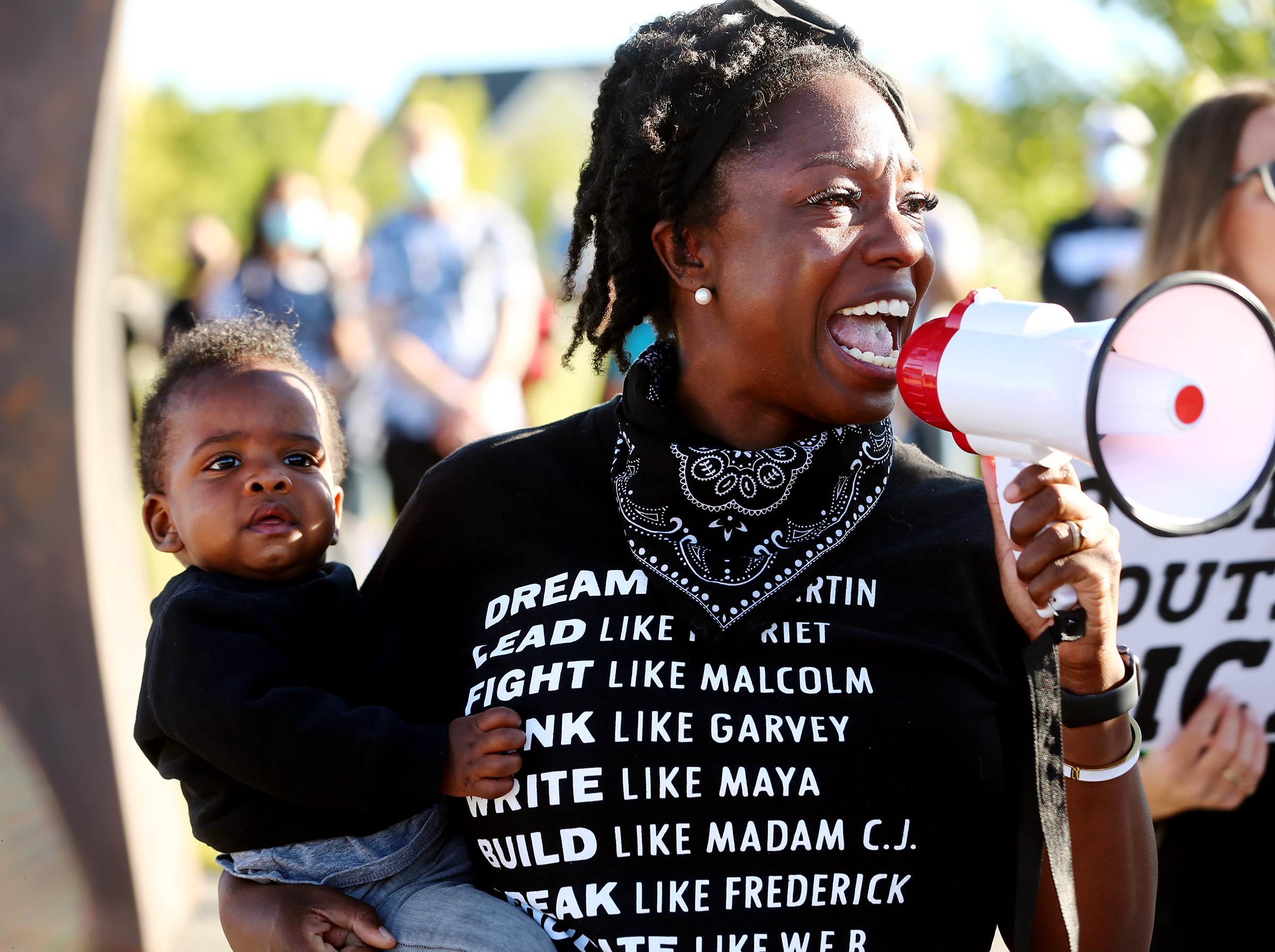 One of the organizers, Sheryl Ellsworth, thanks the crowd for attending as she holds her son Hamilton Ellsworth as several hundred demonstrators gather and march for Black Lives Matter at Daybreak in South Jordan on Wednesday, June 17, 2020. (Scott G Winterton, KSL)
